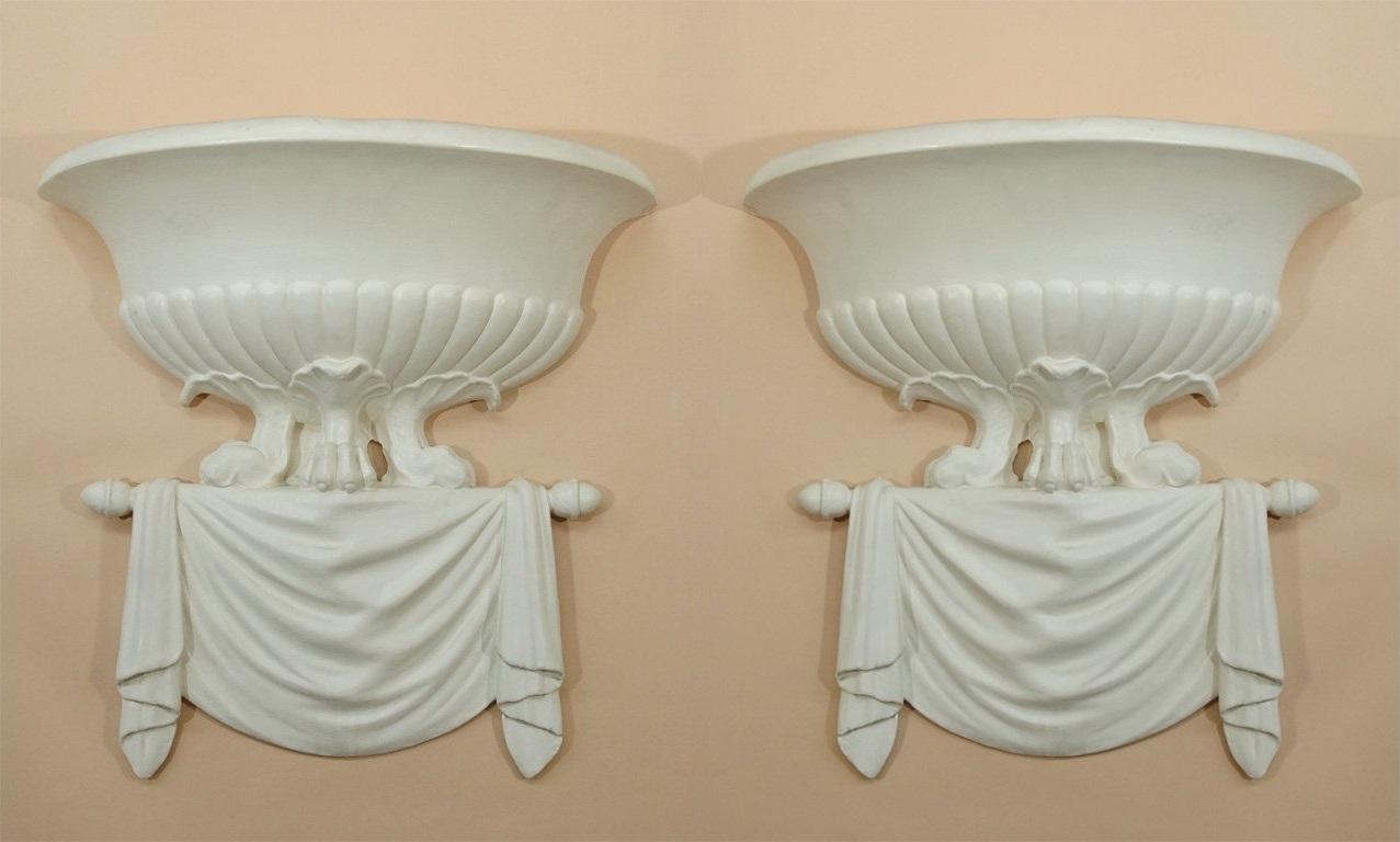Beautiful pair of elegant plaster sconces very much in the style of pieces created by Serge Roche/ Dorothy Draper/John Dickinson. In the modern neoclassical style, ornamentation that is both classic and surreal. Four available, sold in pairs. This