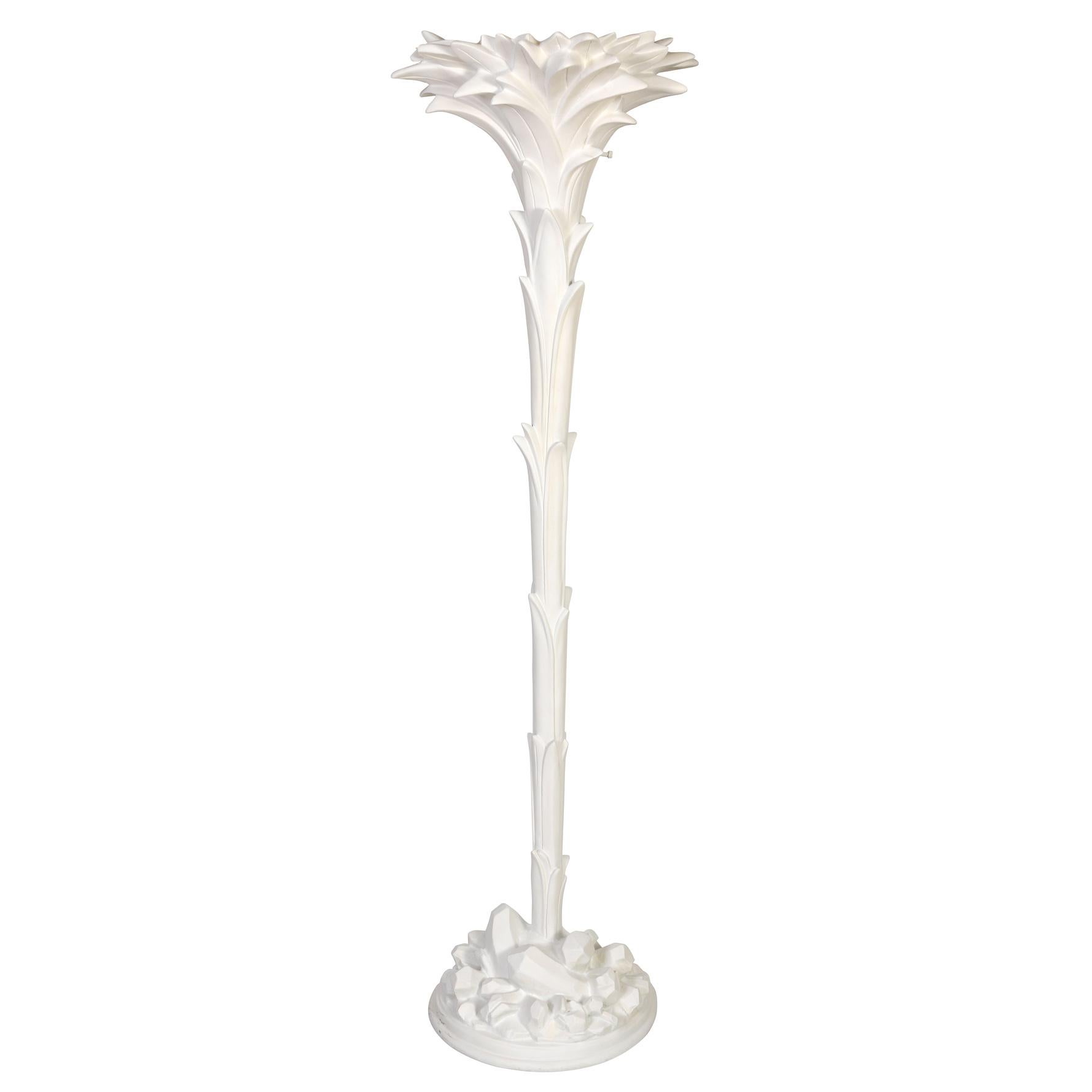 A glamorous pair of Serge Roche style, white palm leaf torchières that effortlessly blend elegant opulence with tropical allure. These exquisite floor lamps seamlessly marry sophistication with a touch of natural splendor, promising to be the