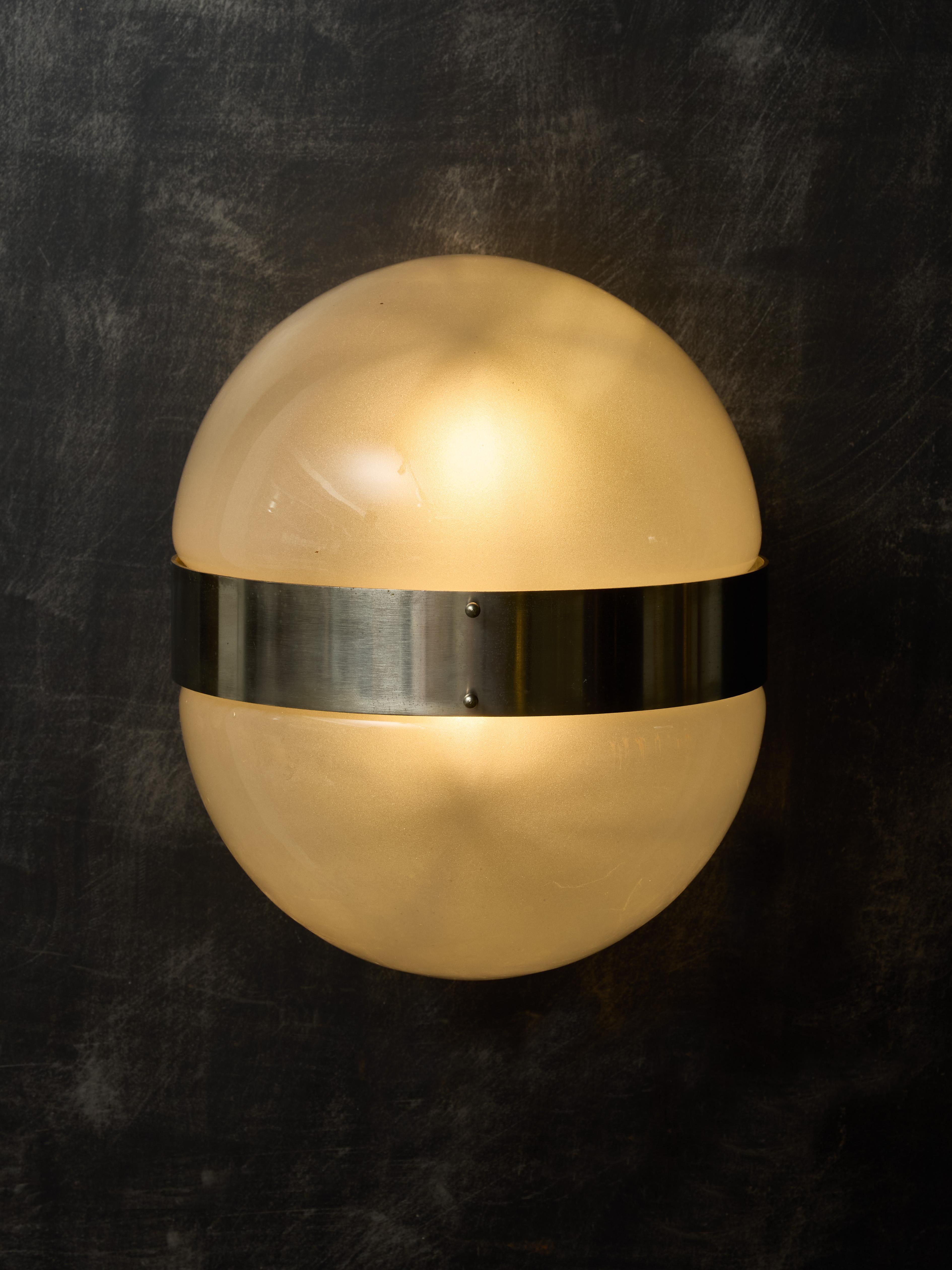 Pair of Clio wall sconces designed by Sergio Mazza for Artemide in the 1960s.

These sconces are made of brushed steel structure holding two sources of light, on which are attached two half glass spheres.

SERGIO MAZZA
Born in 1931 in Milan, Italy,
