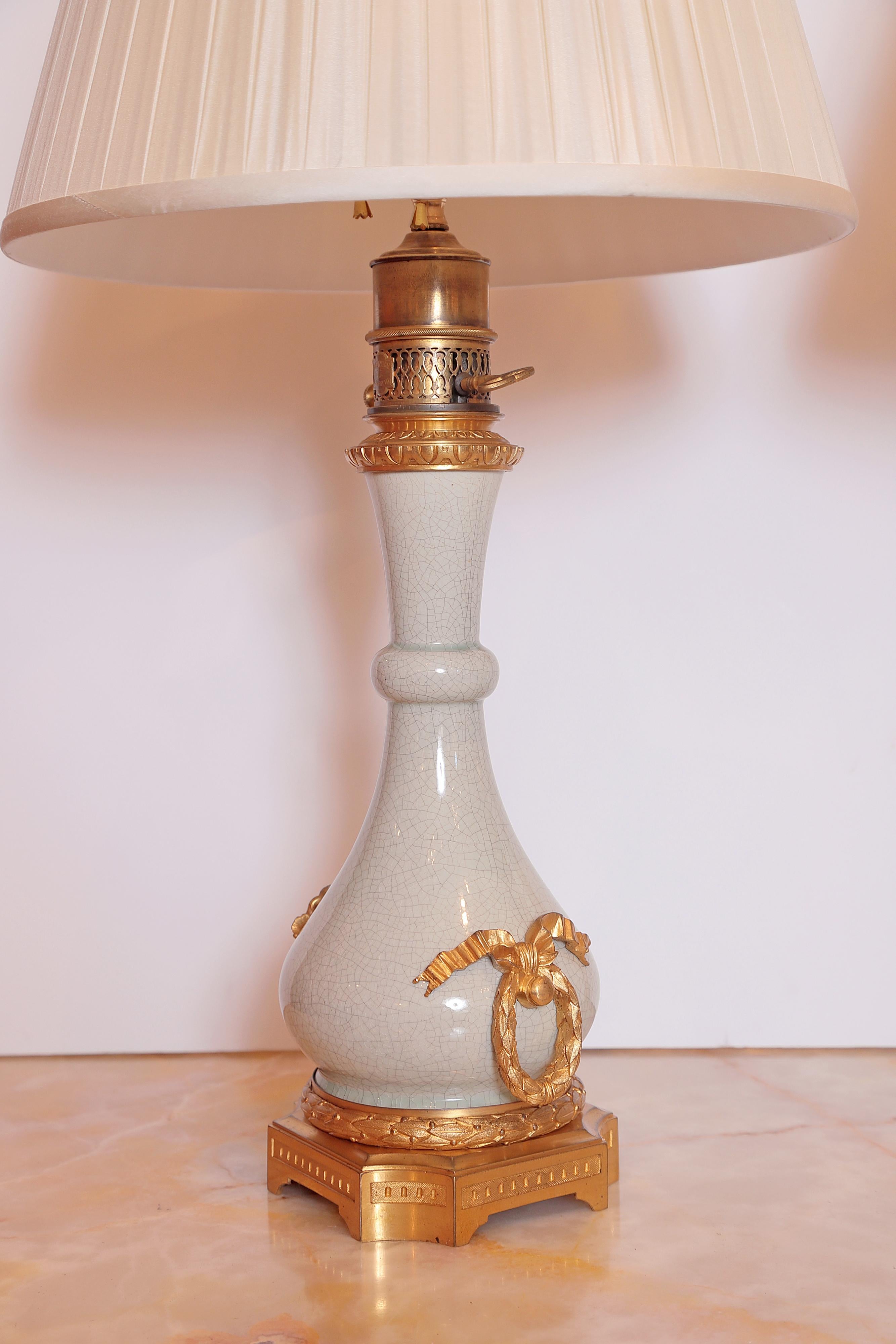 Pair of signed Serve's Porcelain oil lamps with fine gilt bronze mounts by Gagneau Paris. Converted to electric lamps with custom silk pleated shades.