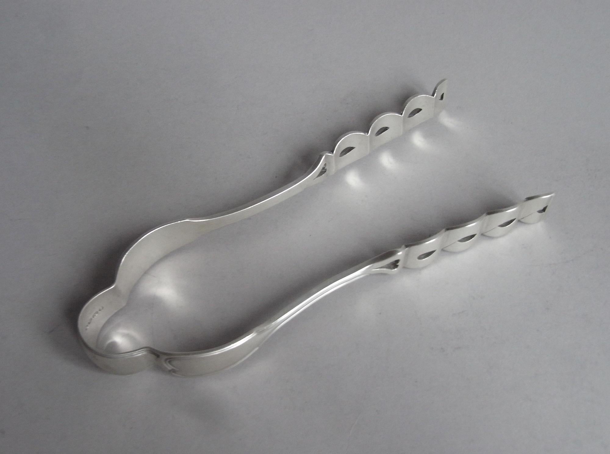 A Very Unusual Pair of Serving Tongs Made in London in 1855 by Francis Higgins

The Tongs have very unusual shaped sides, with a domed top and slender upper section of the arms, all displaying a fiddle and thread pattern border.  The lower section