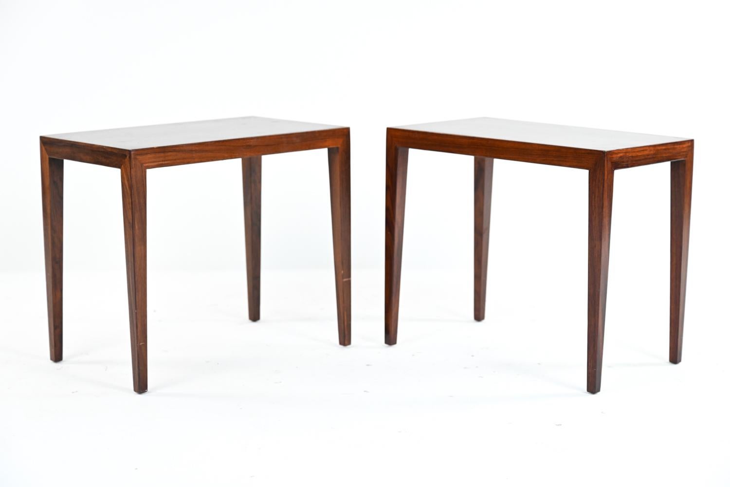 A stylish pair of Danish mid-century tables in rich rosewood with exquisite grain designed by Severin Hansen for Haslev, 1960's. A simple yet attractive form with tapered legs and well-designed proportions. One retaining Danish control label