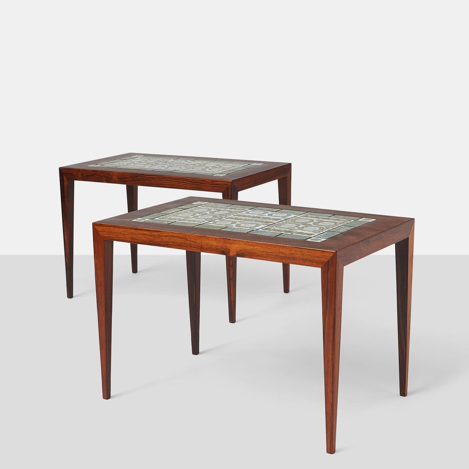A pair of end tables in rosewood with inset ceramic tiles. Manufactured by Haslev Mobelfabrik, the tables were designed by Severin Hansen Jr and the tiles by Nils Thorsson.