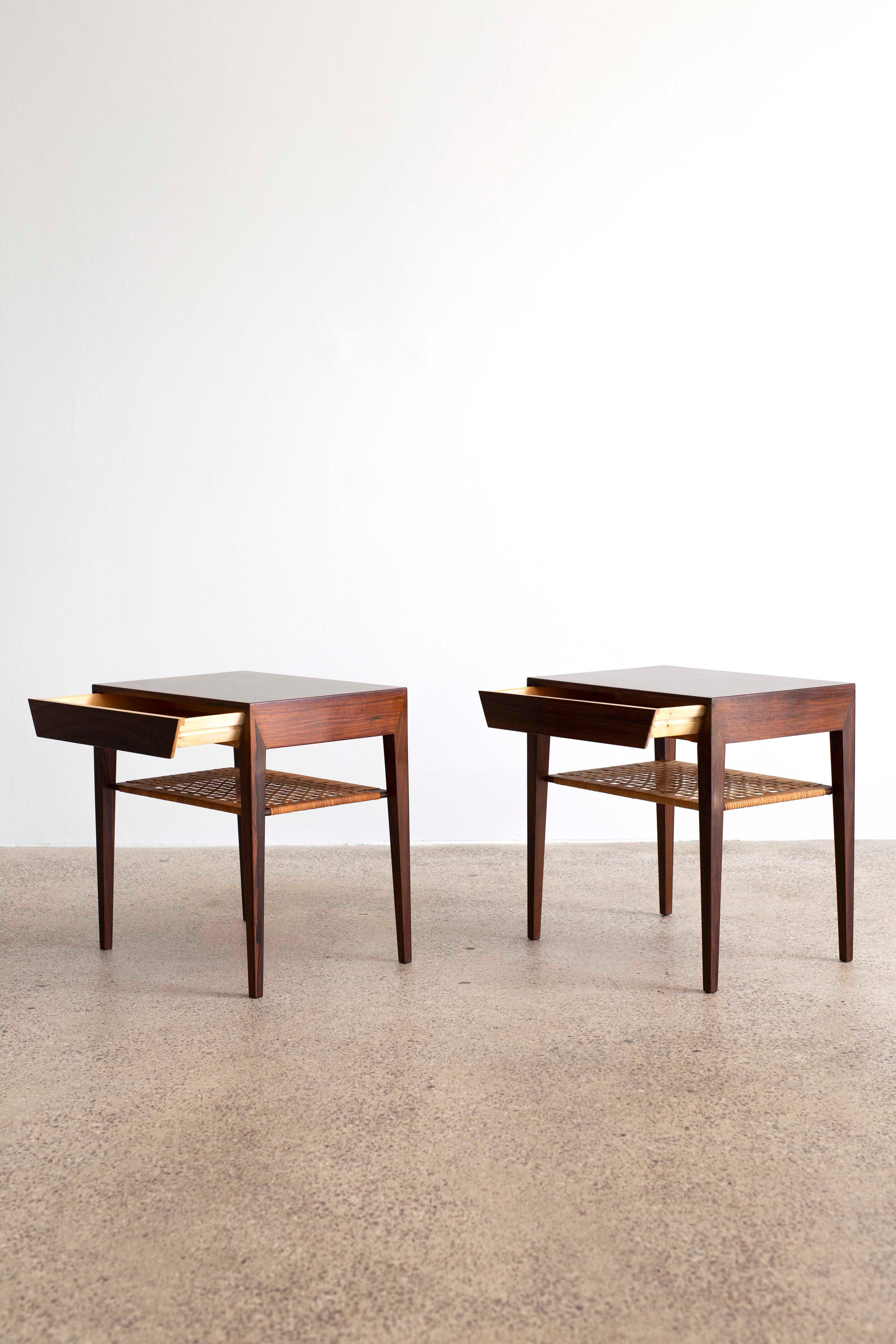A pair of Severin Hansen side tables in rosewood with cane shelf and drawer. Designed by Severin Hansen 1960s and made at Haslev møbelsnedkeri in Denmark. Very fine condition.
