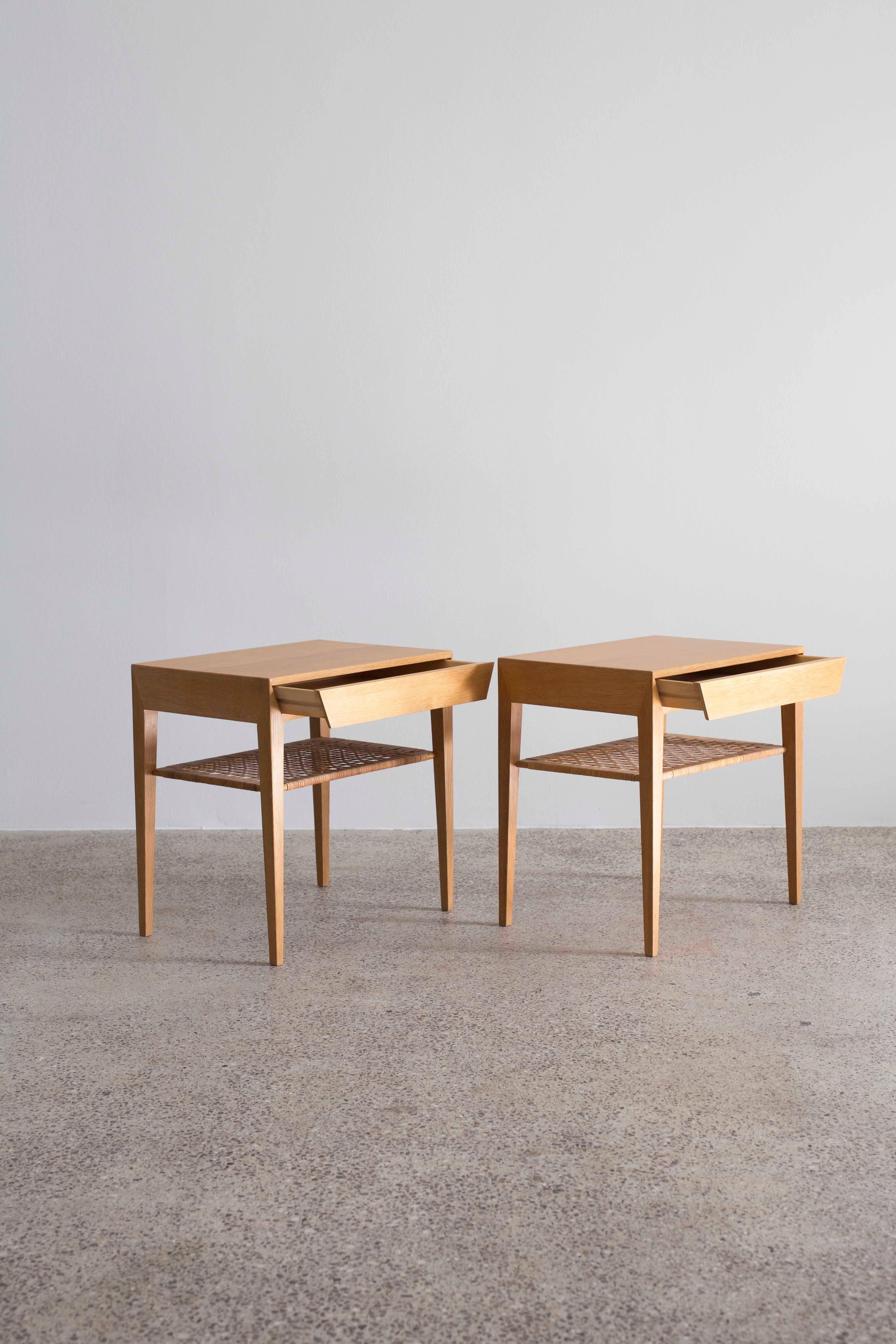 A pair of Severin Hansen side tables in oak with cane shelf and drawer. 

Designed by Severin Hansen 1960s and made at Haslev møbelsnedkeri in Denmark.