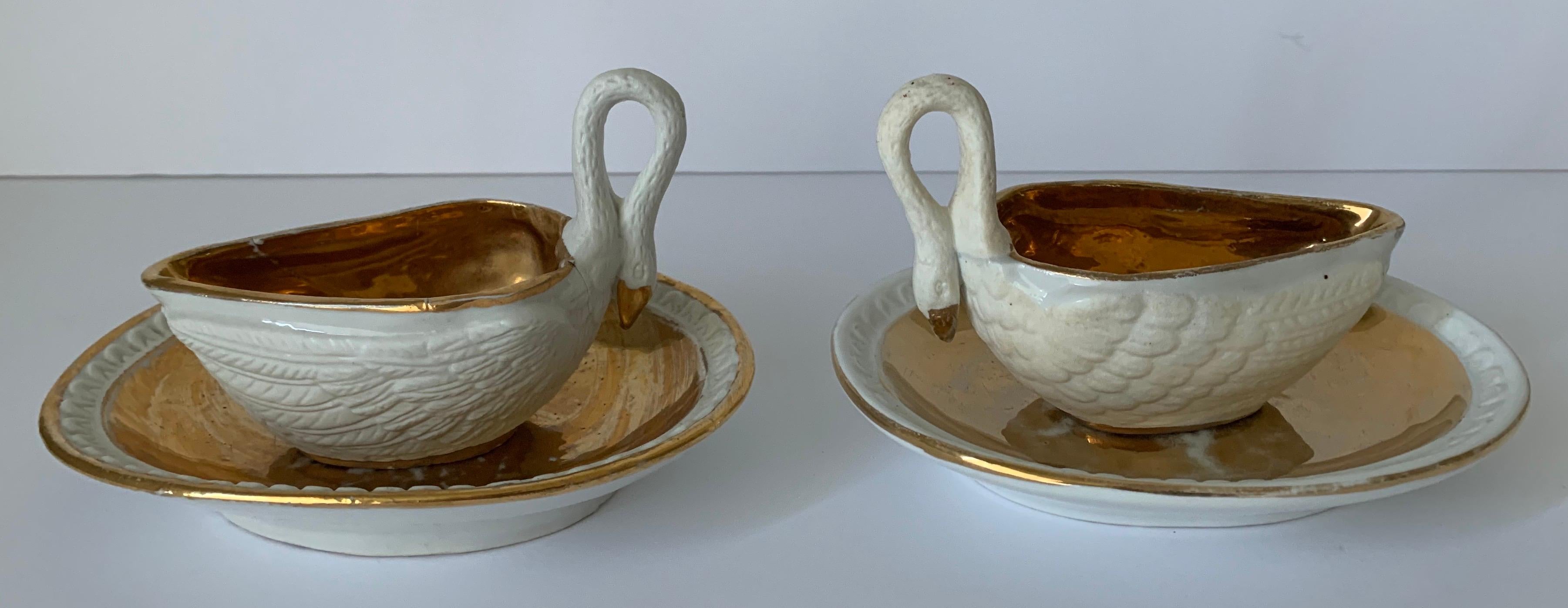 Pair of early 19th century bisque porcelain gilt swan dishes by Sèvres. Each swan and dish varies slightly.