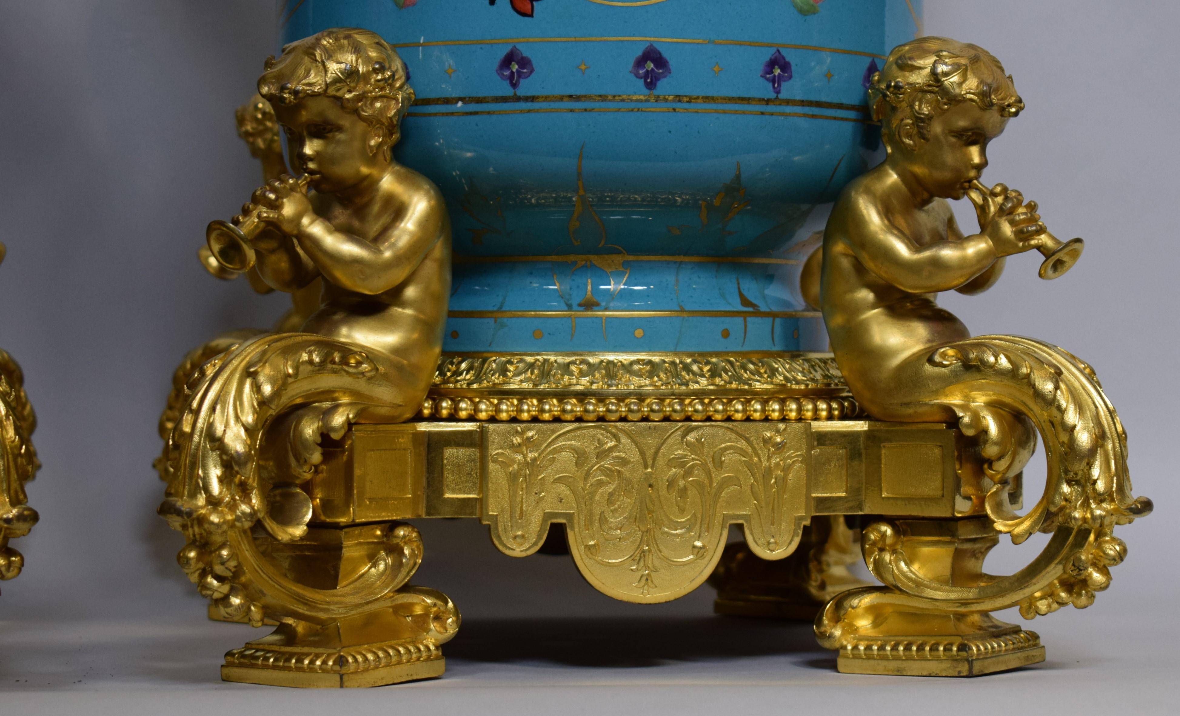 French “Manufacture de Porcelain de Sevres” and Victor Paillard (French 1805-1886), mid to late 19th century. Pair of blue ground floral decorated porcelain urns, painted by Charles Barriat (French, b. 1821). Both pieces having floral decorated gilt