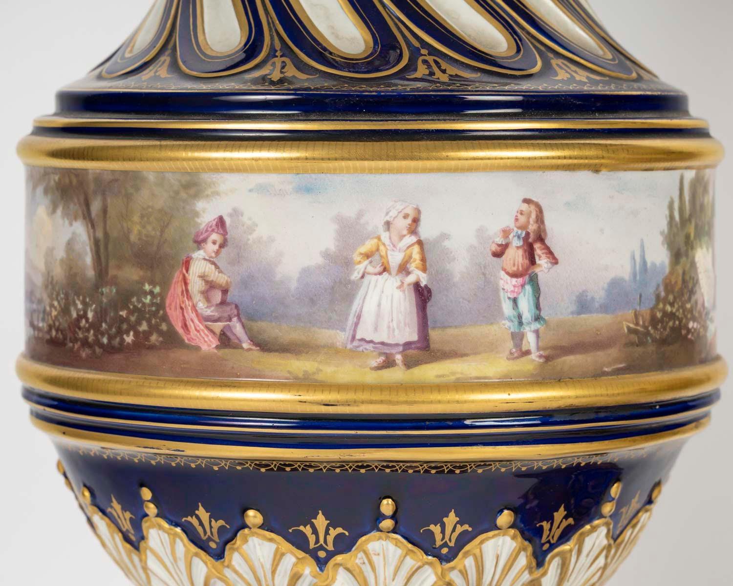 A pair of Sèvres gilt and painted porcelain covered vases with a twisted design, gilt bronze mount, 19th century, Napoleon III period.
H: 58cm, D: 17cm