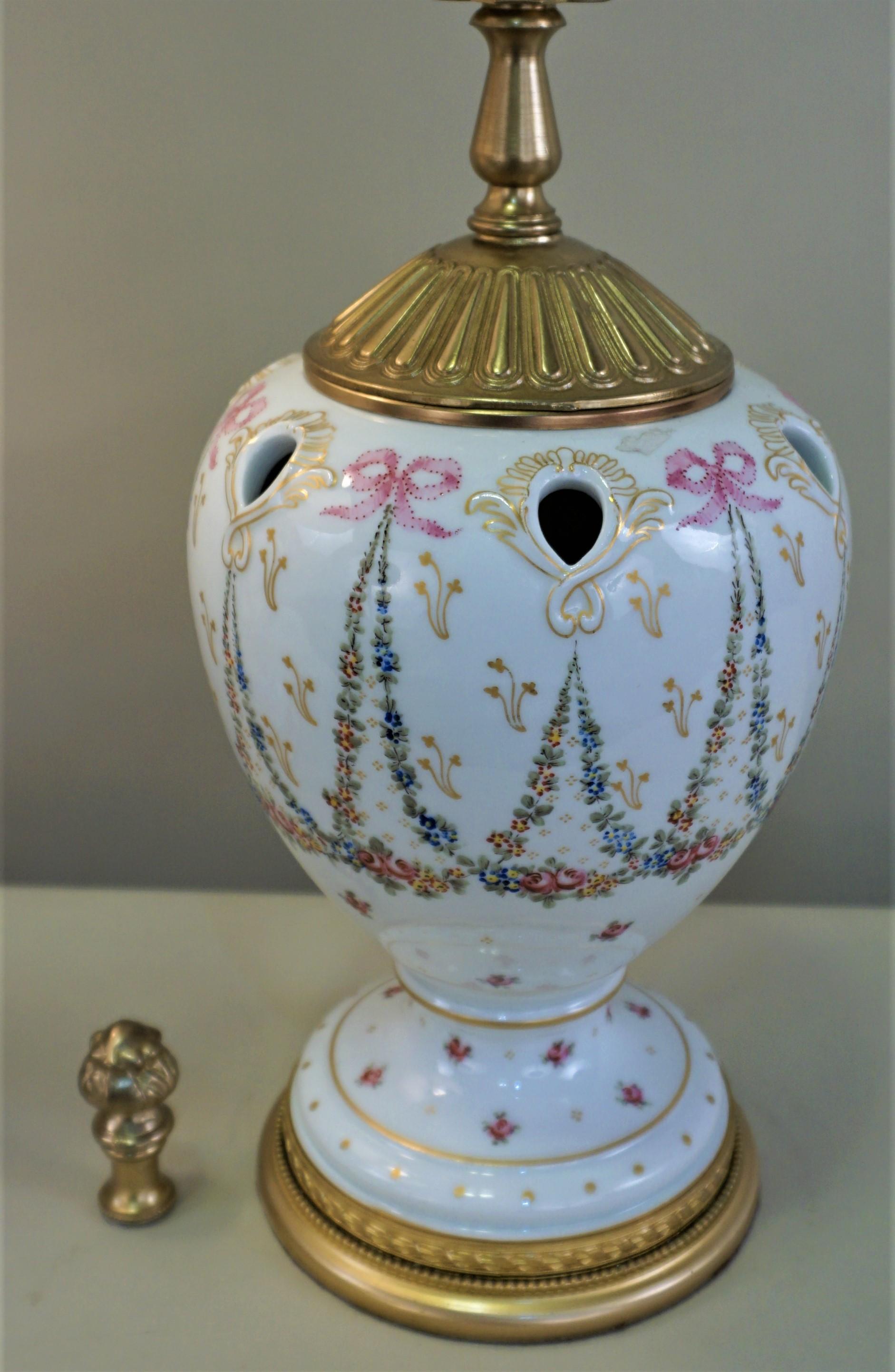 Pair of hand painted porcelain vases with bronze mounting that have been customized to table lamps and fitted with silk lampshades
Measurement include the shade.