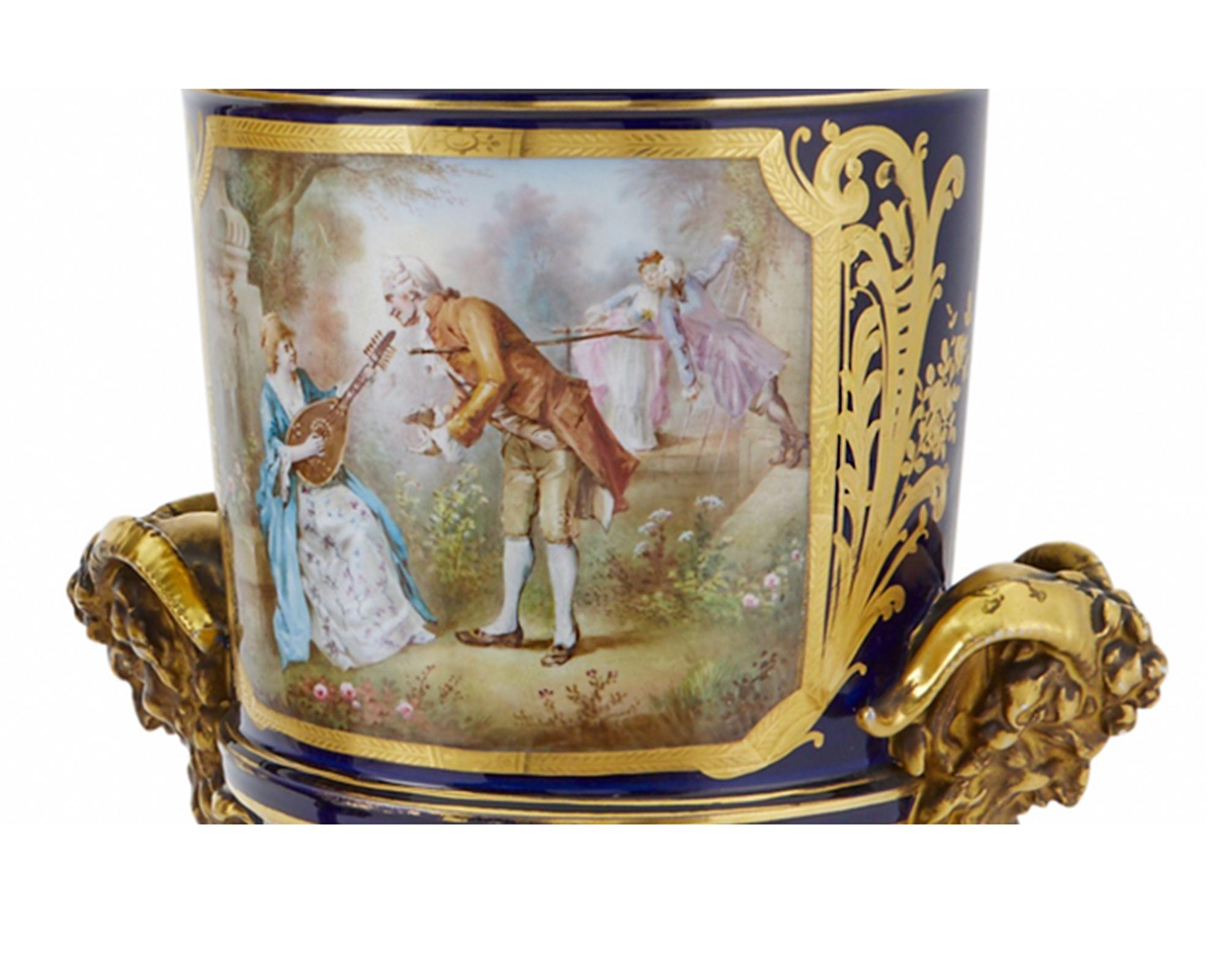 Glazed Pair of Sevres Style Gilt and Polychrome Decorated Porcelain Two-Handled Urns For Sale