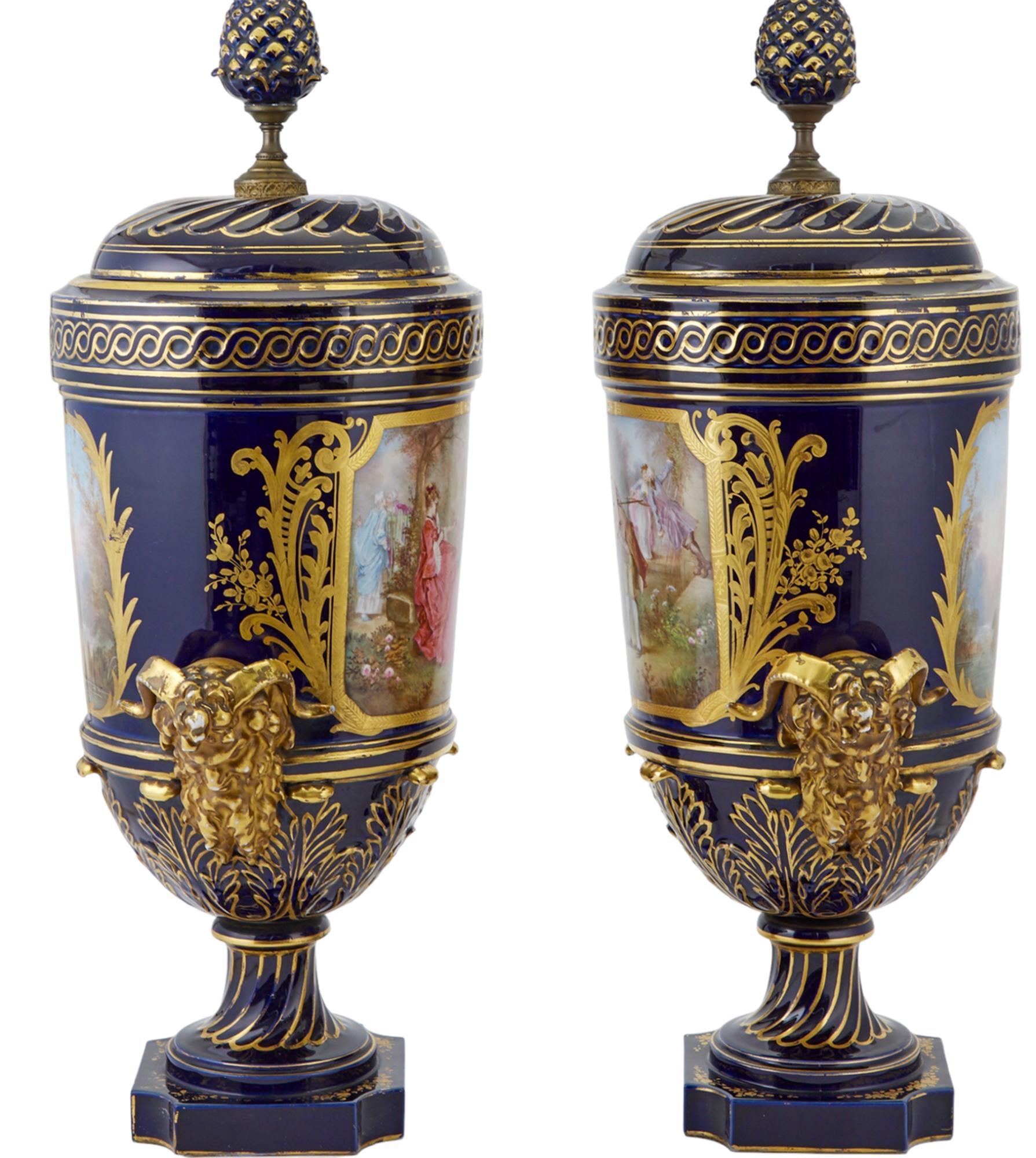 Pair of Sevres Style Gilt and Polychrome Decorated Porcelain Two-Handled Urns In Good Condition For Sale In New York, NY