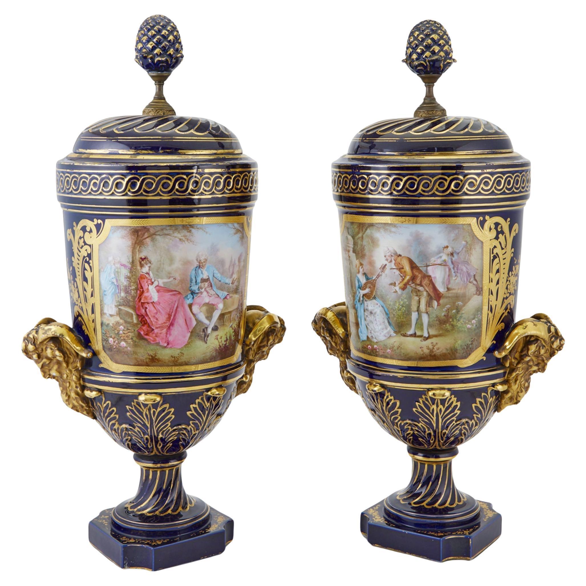 Pair of Sevres Style Gilt and Polychrome Decorated Porcelain Two-Handled Urns For Sale