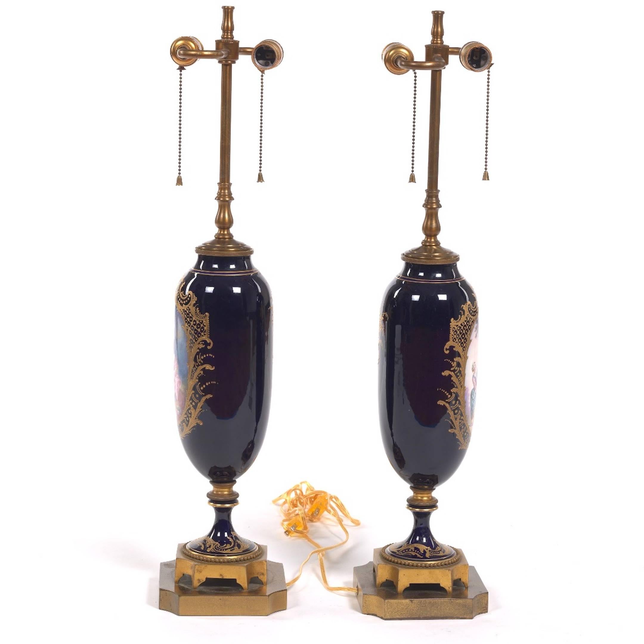 Hand-Painted Pair of Sèvres Style Ormolu-Mounted Urns, Now as Lamps