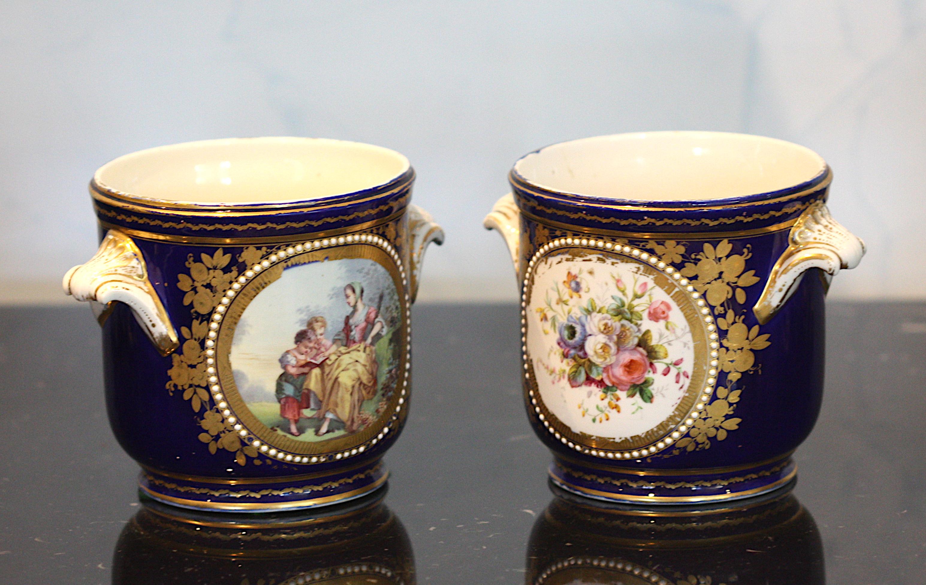 
Pair of Sevres Style Porcelain Cache Pots
19th Century. Each marked with an interlaced L on the underside. The circular bowls are reserved with maidens in a landscape opposed by foliage on a blue de Roe ground, with beading and gilt