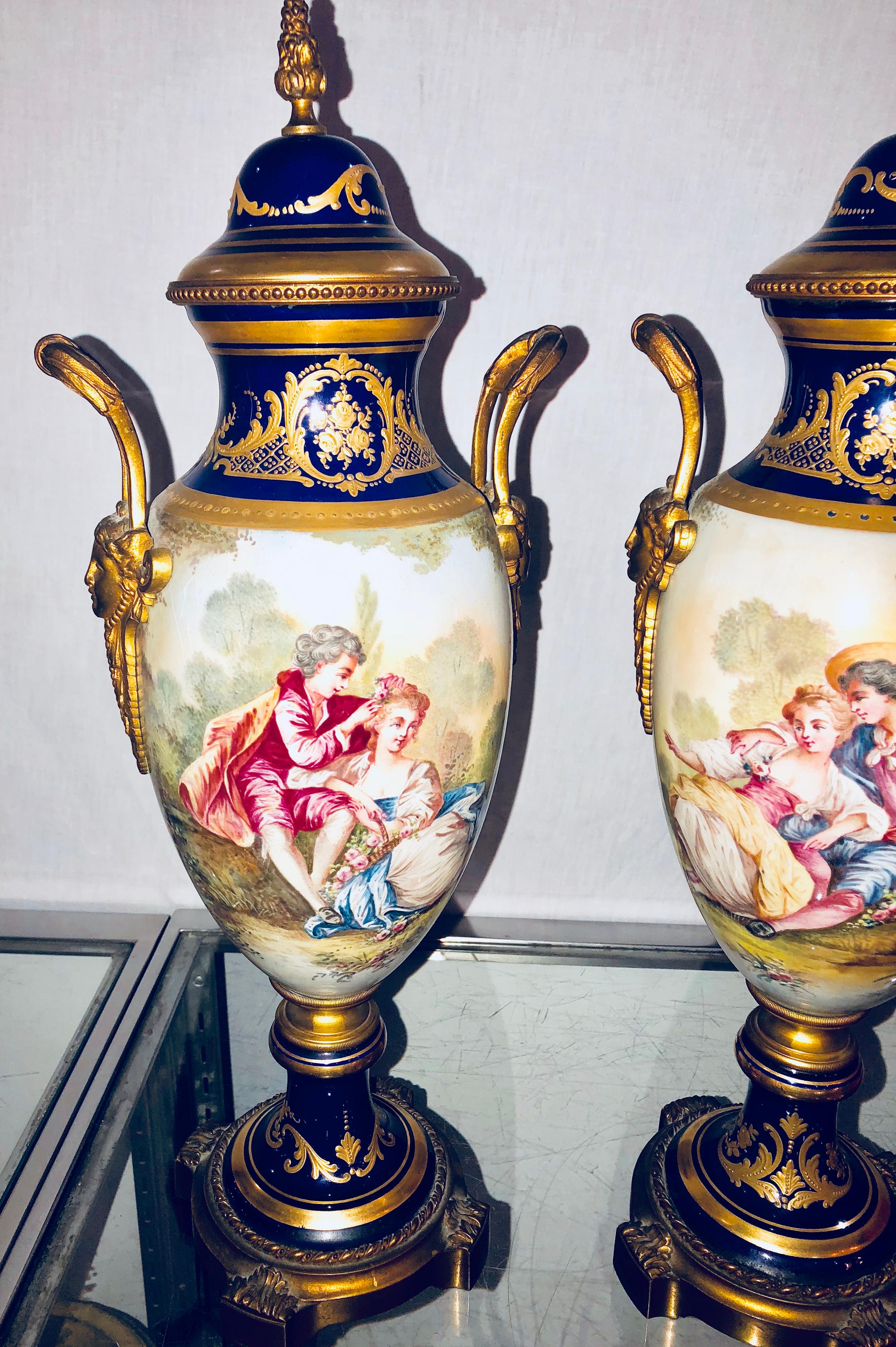 Belle Époque Pair of Sevres Vases Signed with Bronze Mounts and Masked Handled Sides