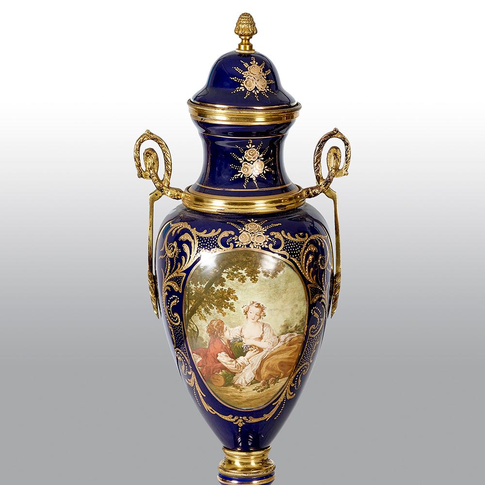 A pair of Sèvres covered vases with bronze mounts with classical scenes.