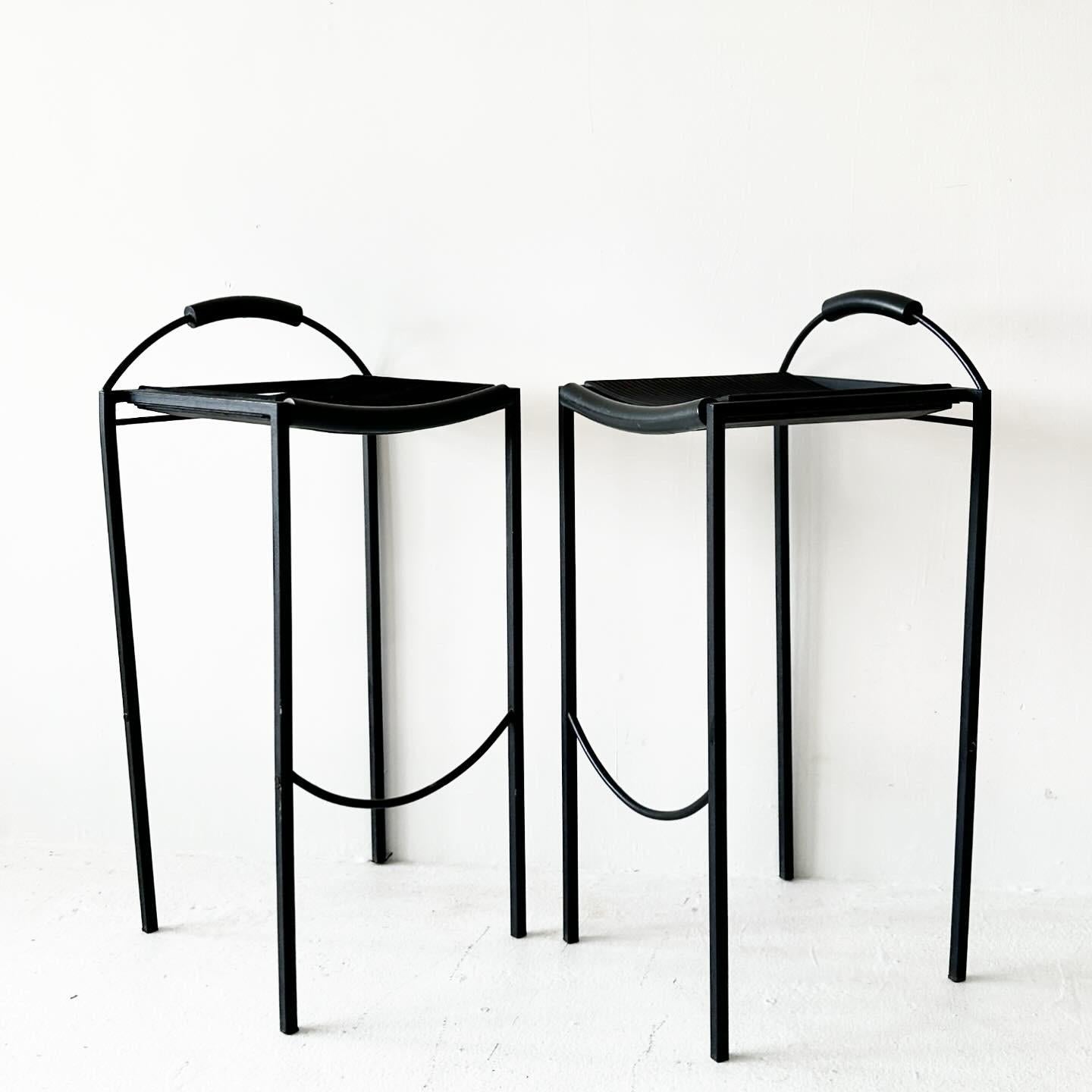 Pair of Sgabello Alto Stools by Maurizio Peregalli. Made in Italy, 1984.

W15.75 D14.5 H32 SH27.5

Wear consistent with age. Compared to other pieces like this online, it appears that bars joining the legs have been removed.

