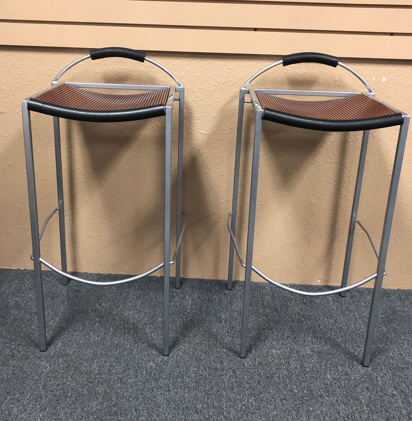 Pair of Sgabello counter stools by Maurizio Peregalli for Zeus, circa 1990s. The seats are a dark brown wood on a steel base with black rubber accents; very stylish!