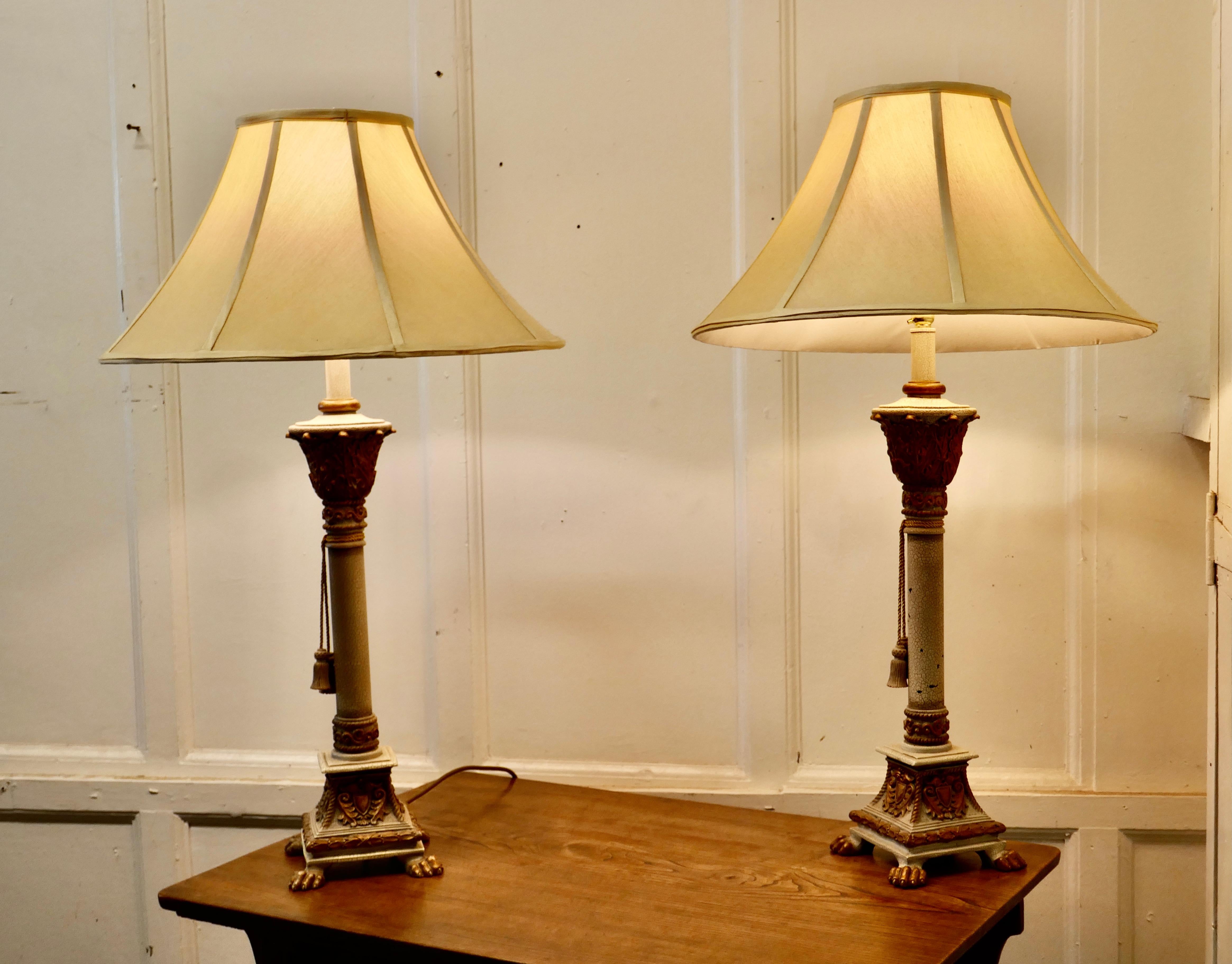Pair of Shabby Crackle Painted Corinthian Column lamps 

These are very attractive lamps, they are in turned wood which is painted in a light blue/grey, the paint has developed a crackle finish
The lamps have a gilt decorated top and base, the