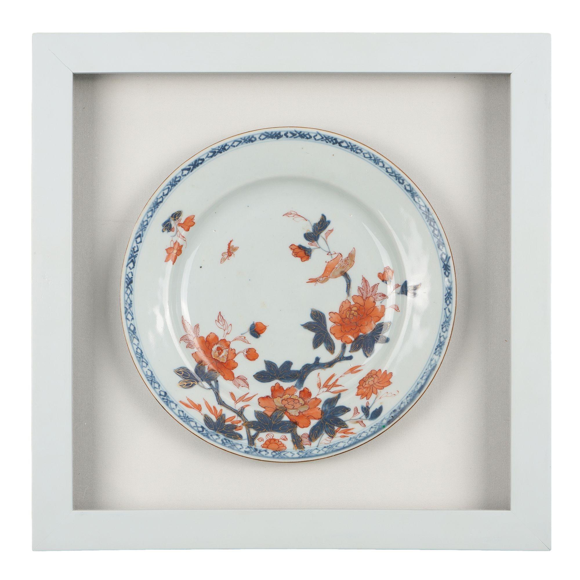 Pair of Chinese export porcelain plates decorated in the the Imari taste. The plates are decorated in cobalt underglaze blue and oxide red with gilt highlights. The asymmetrical design of flowering peonies with a magpie is bordered with a band of