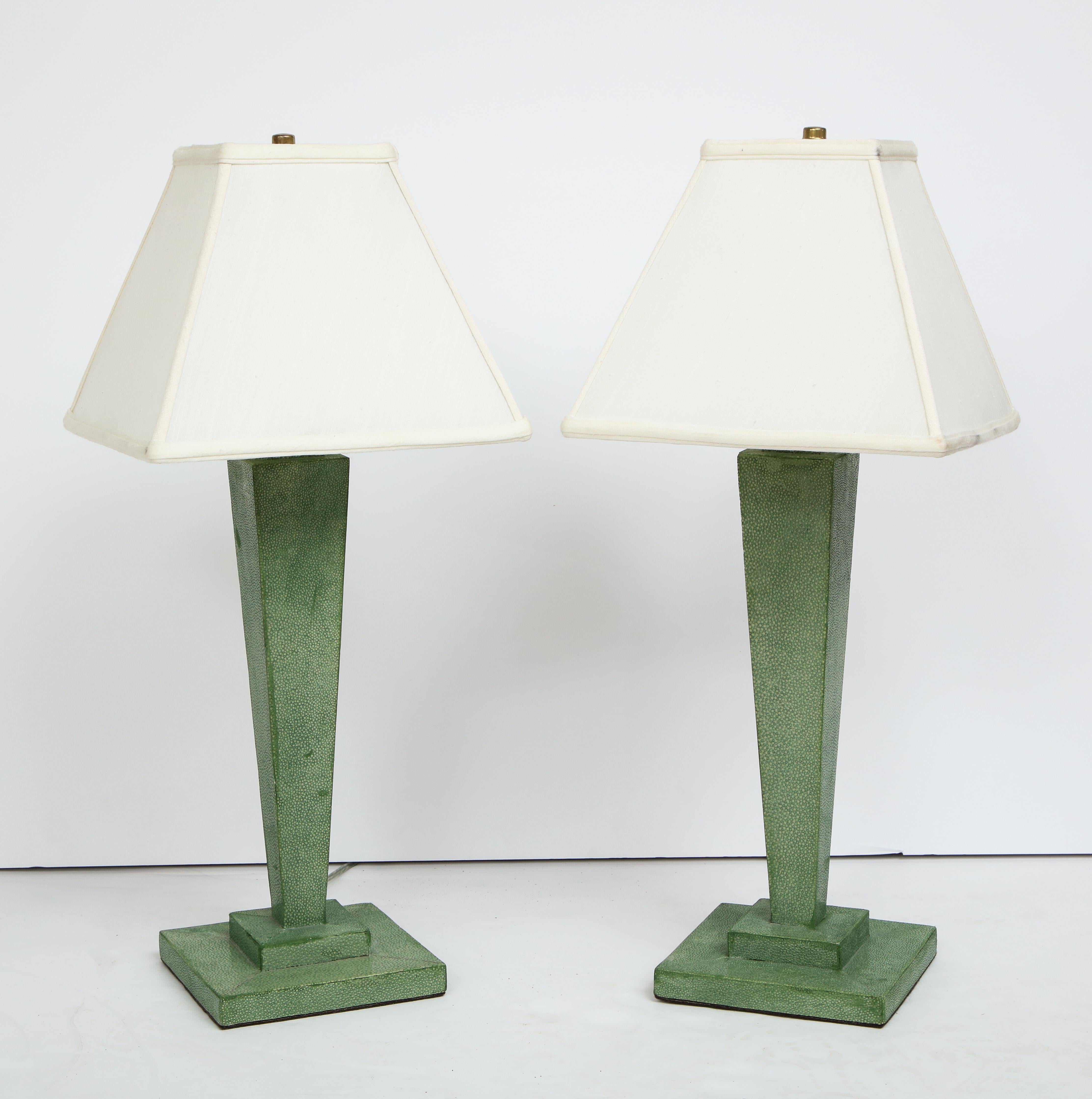Green shagreen leather covered lamps with ivory silk shades