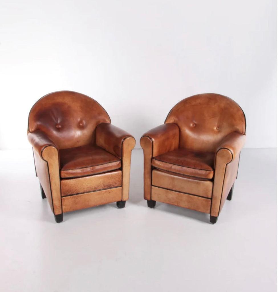 Pair of chestnut sheep's leather club chairs, designed by Bart van Bekhoven in the 1970s. Sheep's leather is recognized as one of the softest leathers, and ages particularly well. The pair is notable for their soft Neo-modernist lines and handsome,