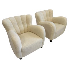 Pair of sheepskin loungers in the 1669 series by Fritz Hansen, Denmark.