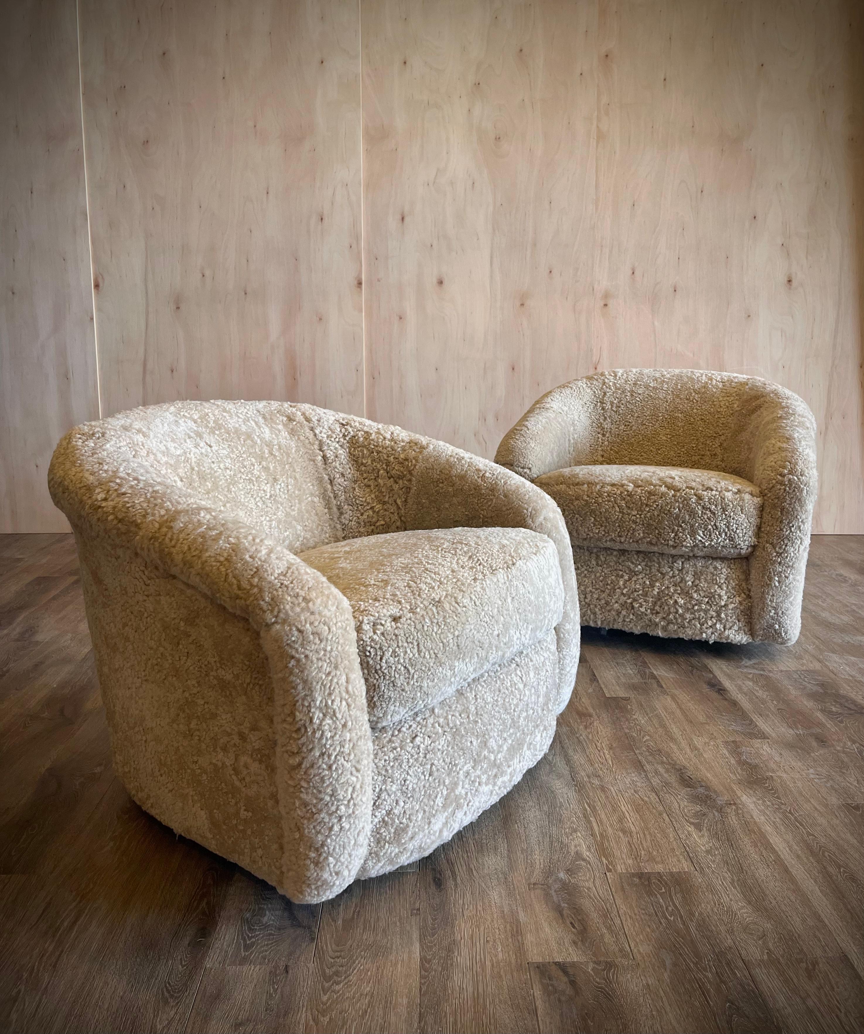 Newly reupholstered in our ‘Oyster’ Sheepskin. It is a wonderful muted neutral, 
sure to fit in any aesthetic.  They are not only a show stopper, but they are comfortable for lounging. And they swivel. 

This listing is for a pair. There are two