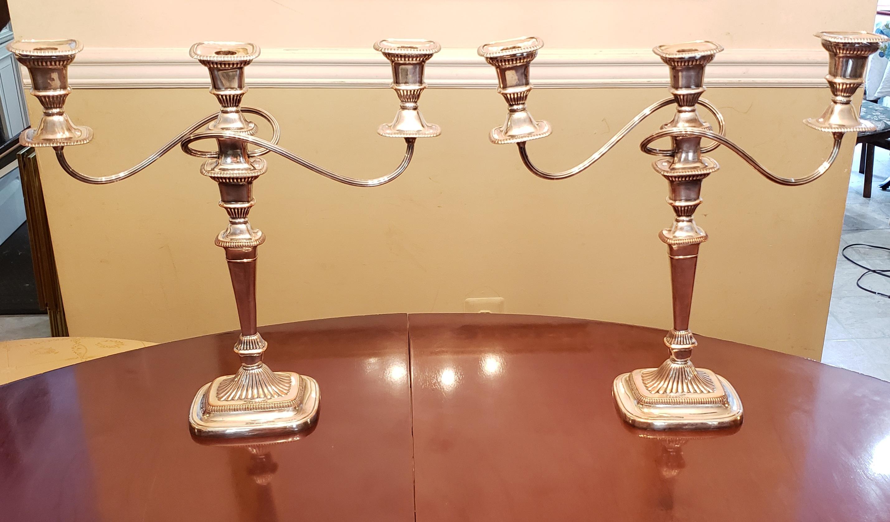 Pair Sheffield silverplated convertible three light candelabras with brass trims.
Measures 17