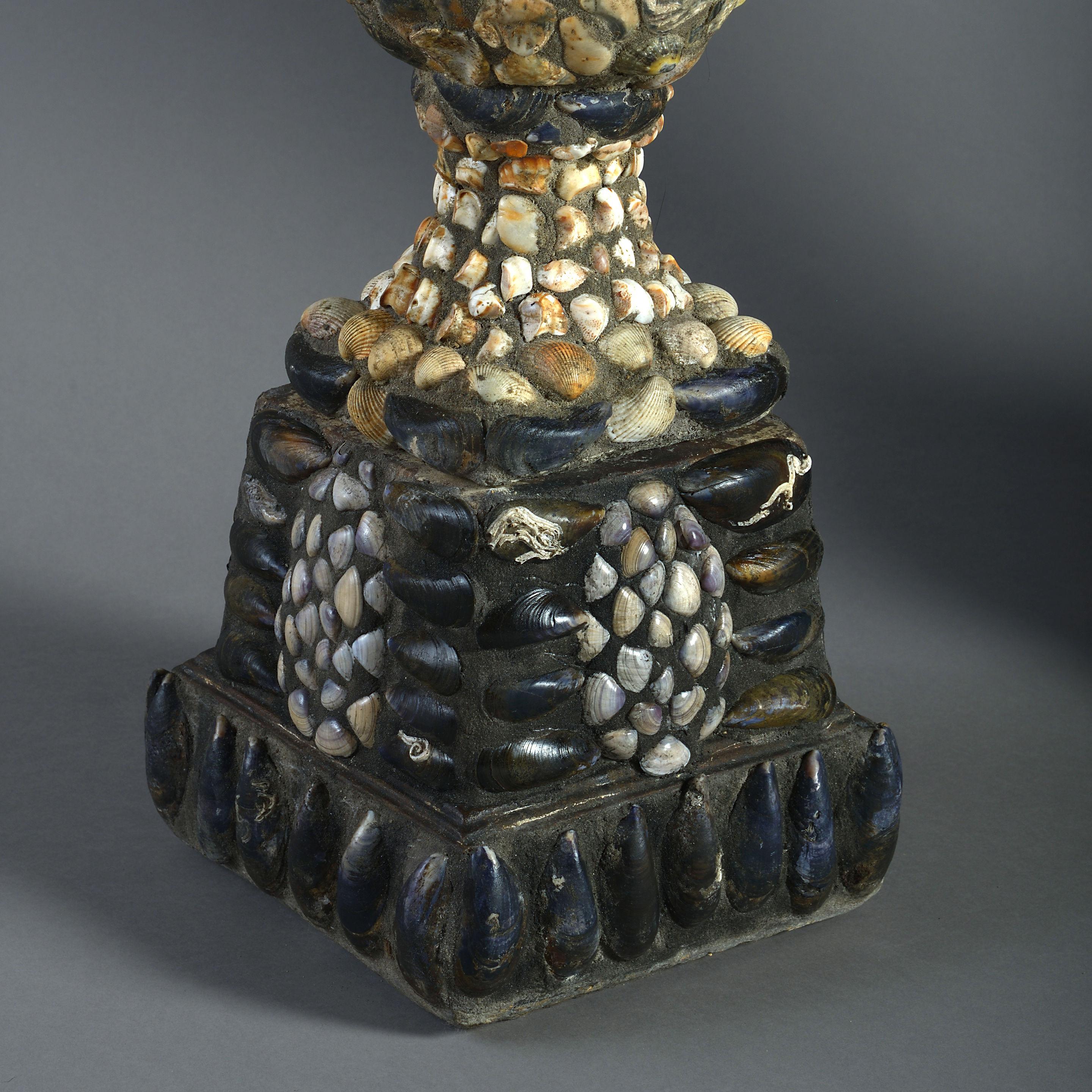 Contemporary Pair of Shell Encrusted Urns on Plinths