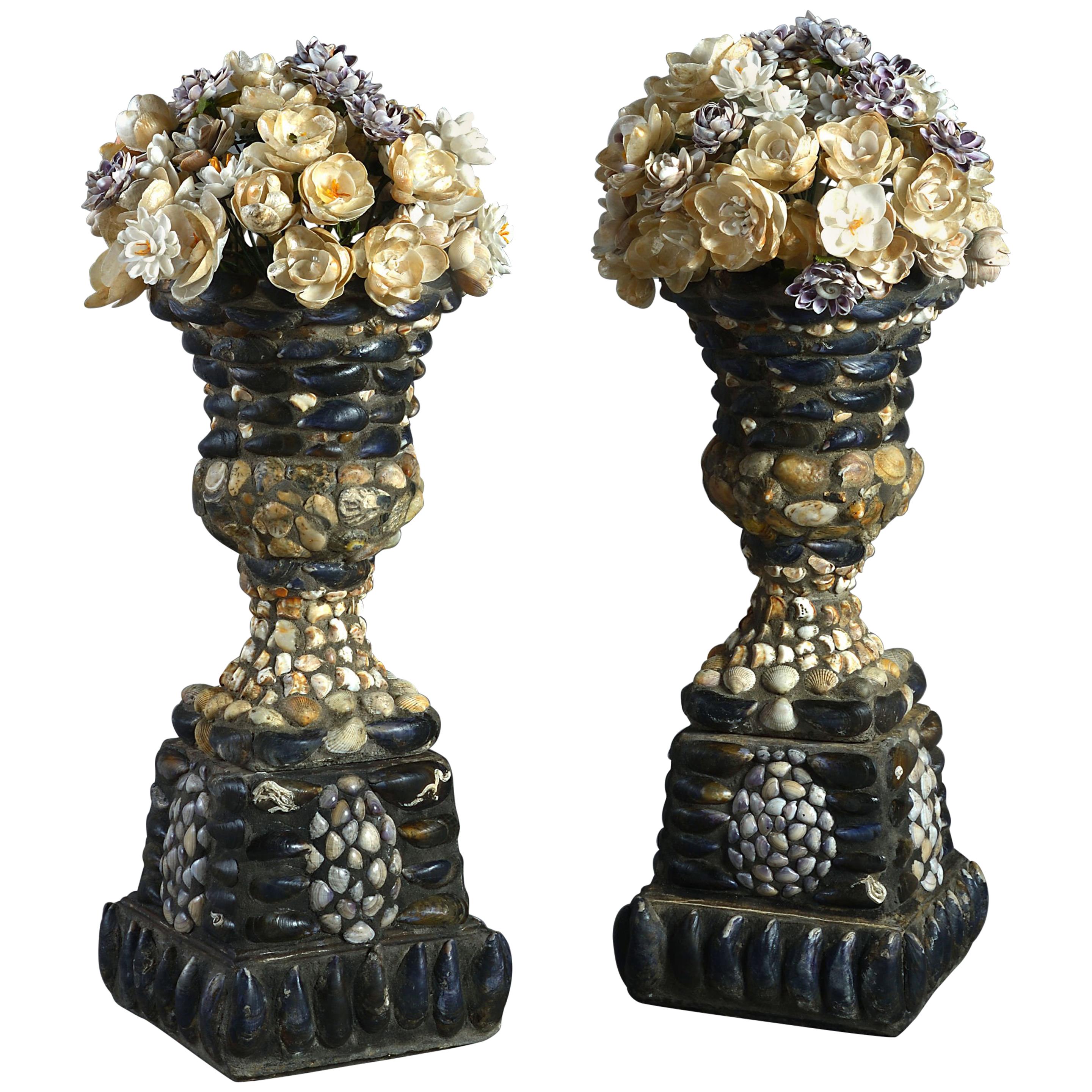Pair of Shell Encrusted Urns on Plinths