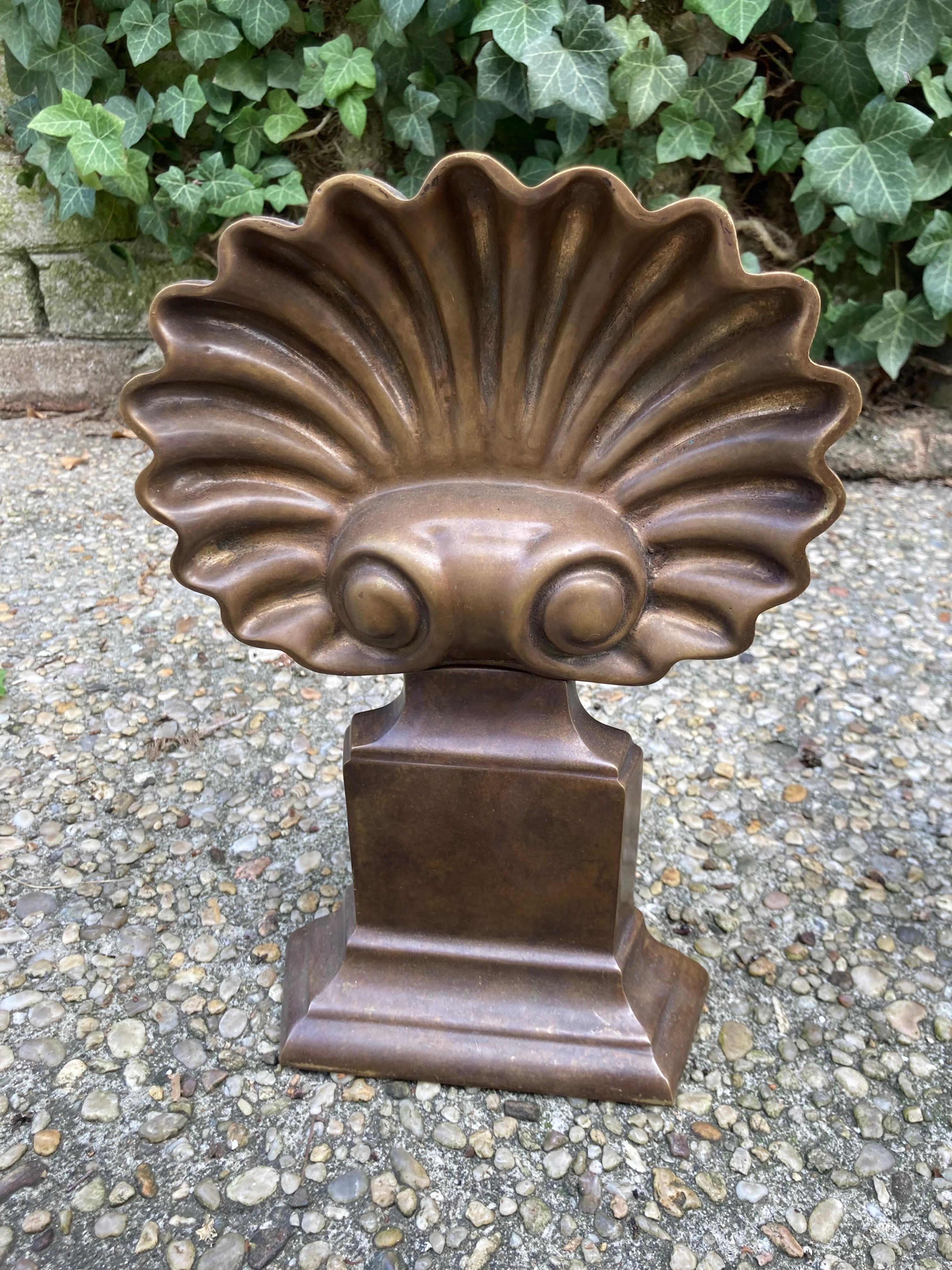 Very nice pair of shell shaped bronze andirons in the grotto style.... very good condition and a lovely deep patina.