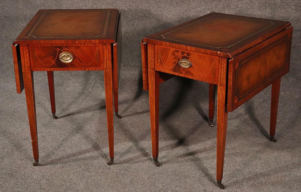 These beautifully made Sheraton style 1940s era 1-drawer Pembroke tables have a great inlaid mahogany cases and tooled leather tops. The hardware is slightly different but that is hardly noticable when they spaced apart.
