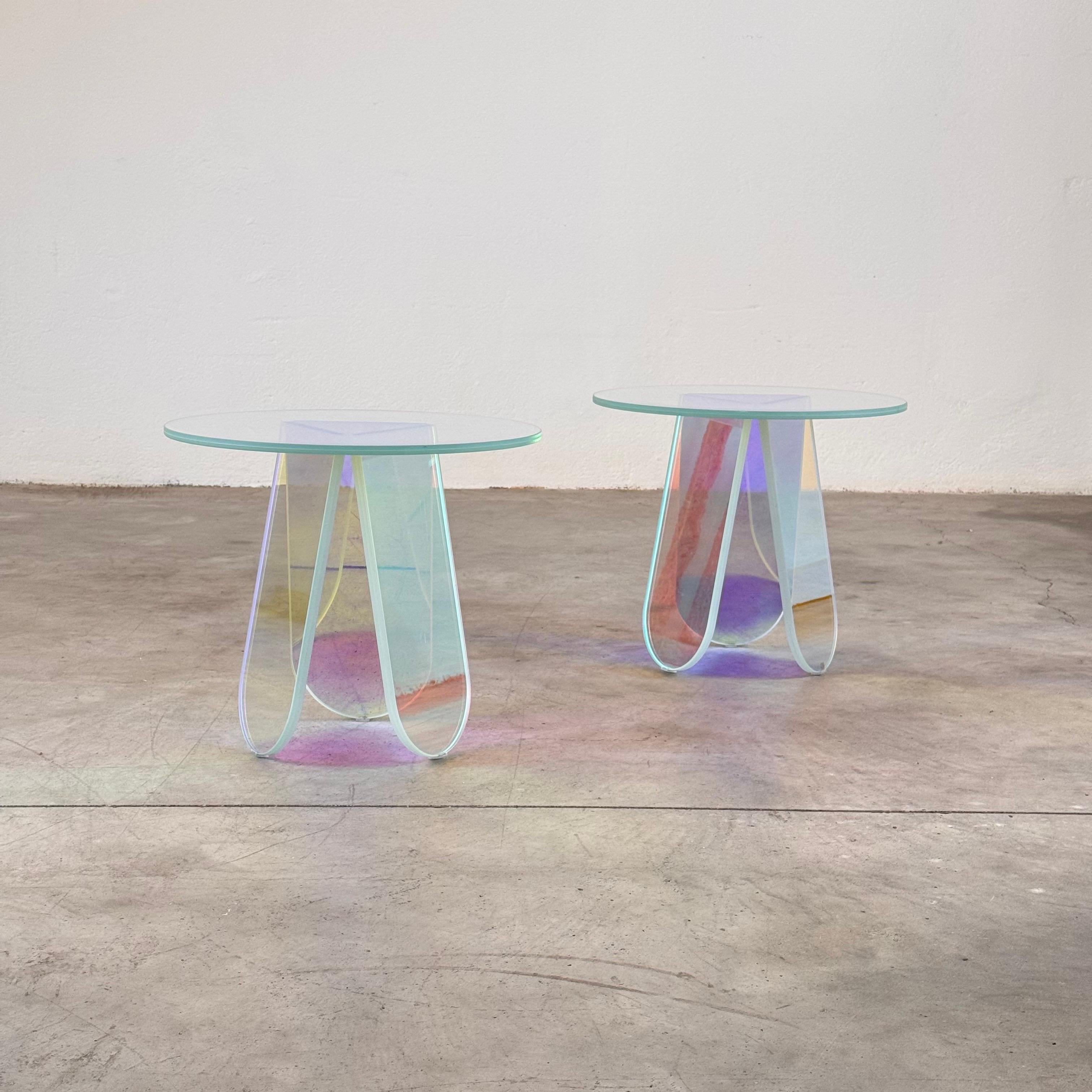 A stunning pair of Shimmer side tables/coffee tables, designed by renowned Patricia Urquiola for Glas Italia. These rounded tables (52 cm diameter x 42.5 cm height) are crafted from laminated and glued glass, featuring an extraordinary iridescent