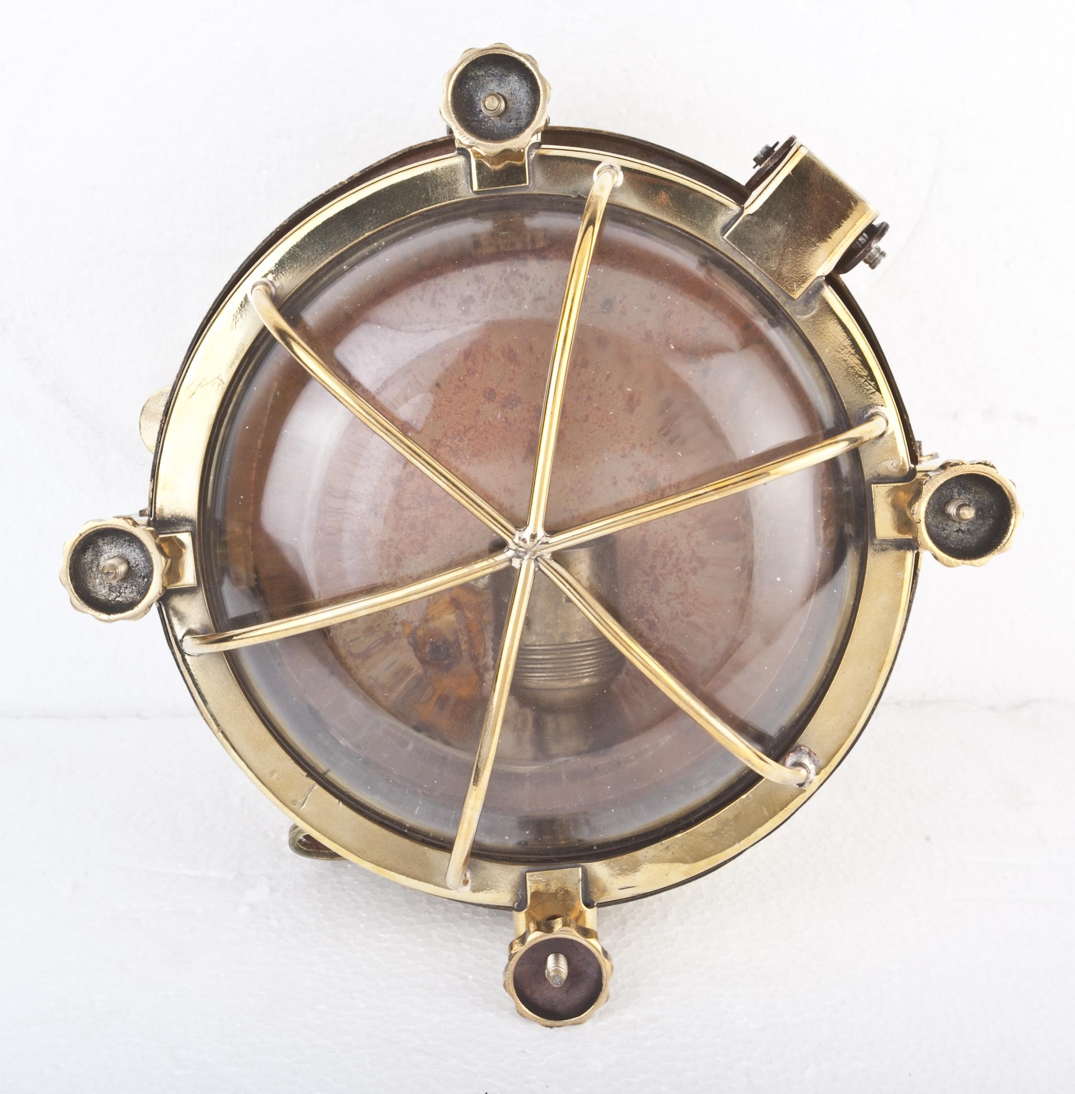 Pair of ship's passageway lights from a decommissioned 1970s ship. Four turn-keys lock in place and once loosened and turned aside, allow the domed glass and brass cage to open with the hinged side. Rewired for American use and take a standard base