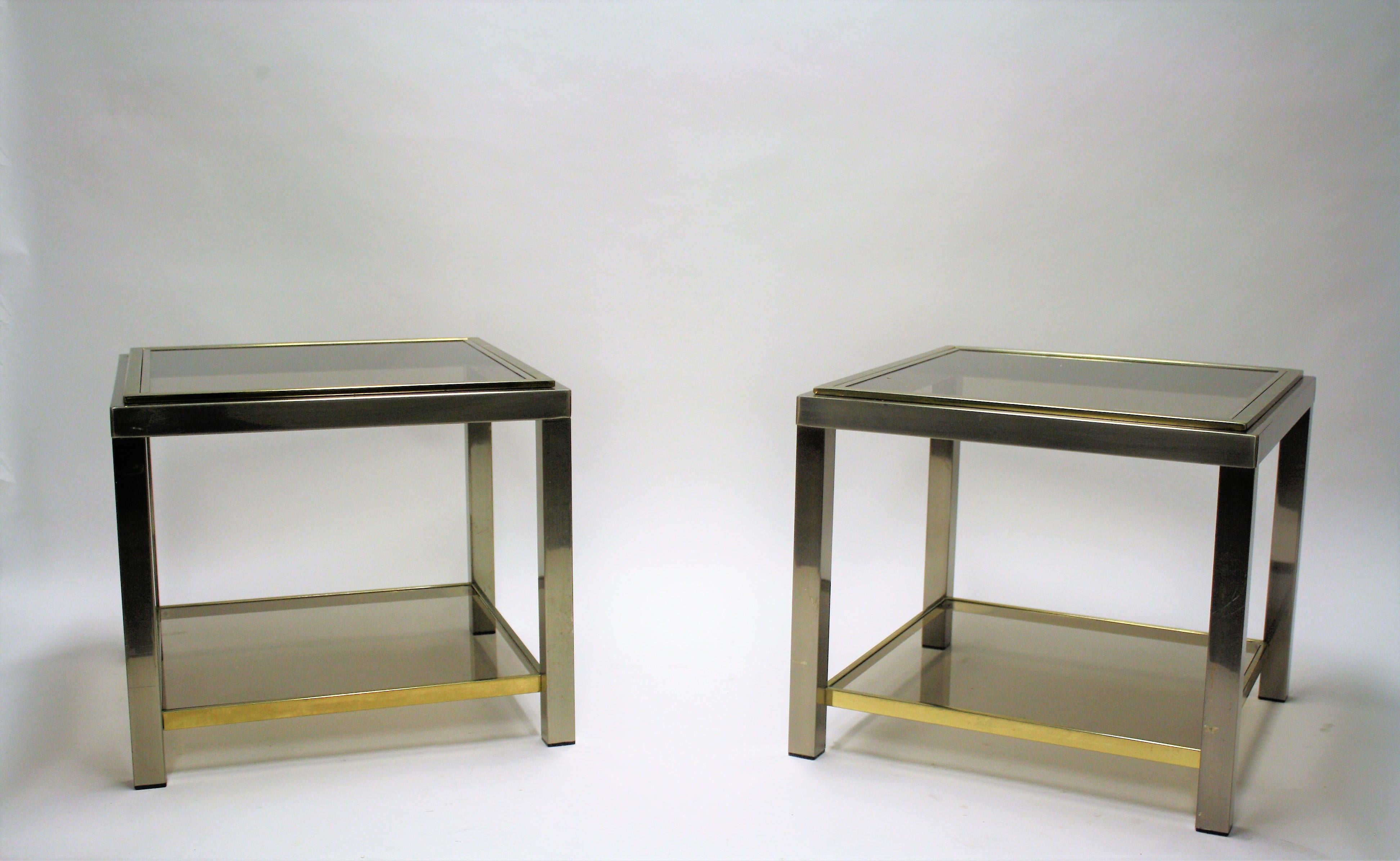 Pair of two tiered brass and chrome side tables by Jean Charles.

Light wear on the brass, light scratches on the glass.

Measures: Height 51cm/20.07