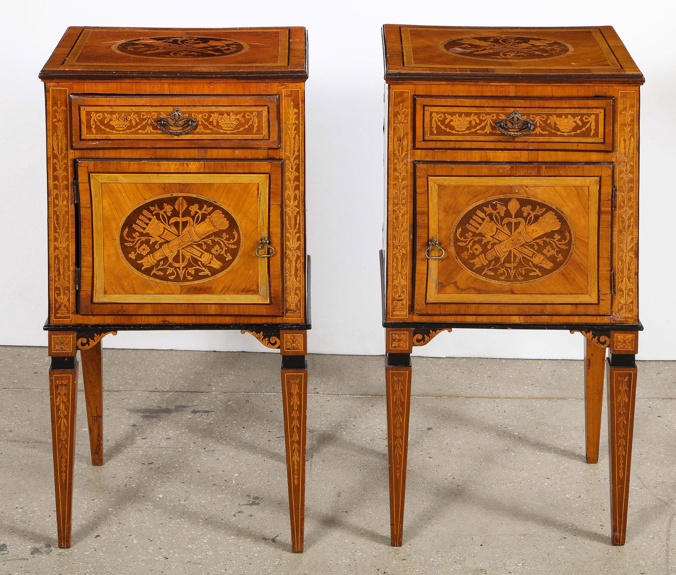 Pair of Italian neoclassic marquetry commodes.

The pair of Italian neoclassic marquetry commodes, having an intricate lyrical marquetry motif on the top, over an inlaid drawer over a single door, the door and sides with marquetry similar to the