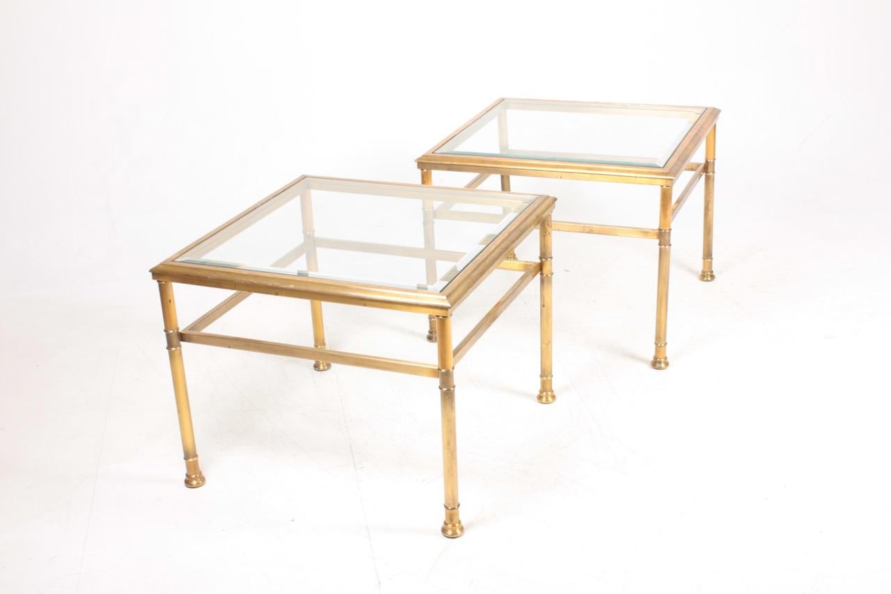 Pair of side tables with glass top on a brass frame. Great original condition.