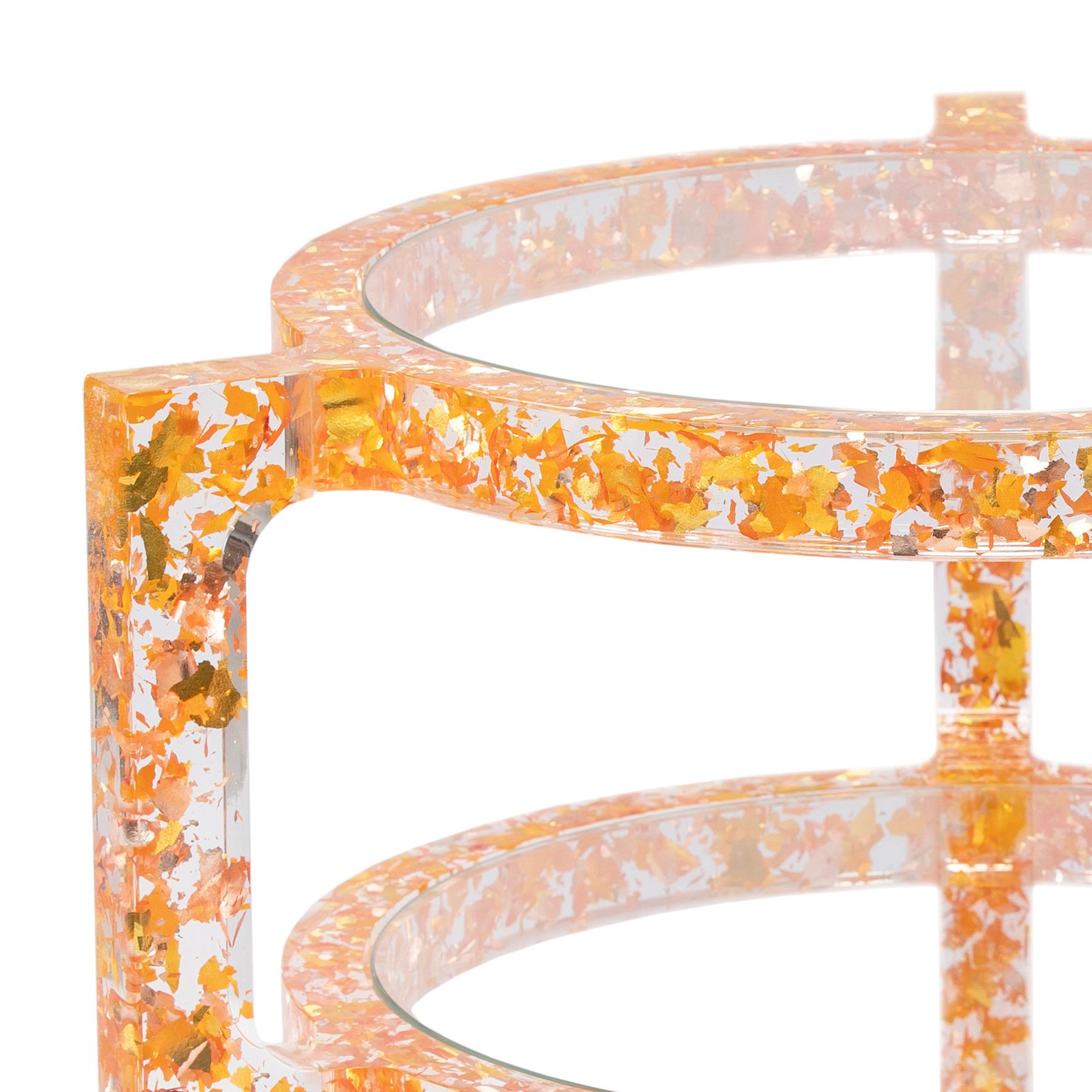 The MIDAS side table is comprised of carefully shredded colored silver-leaf, all left to randomly float in the table’s crystal clear acrylic frame. Light bounces and reflects off the leaf providing a confetti-like pattern and a unique fragmented