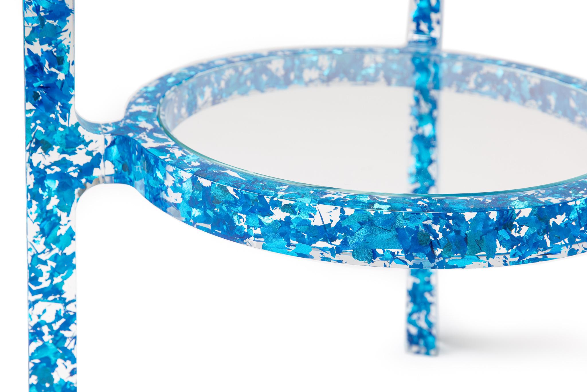 The MIDAS side table is comprised of carefully shredded colored silver-leaf, all left to randomly float in the table’s crystal clear acrylic frame. Light bounces and reflects off the leaf providing a confetti-like pattern and a unique fragmented