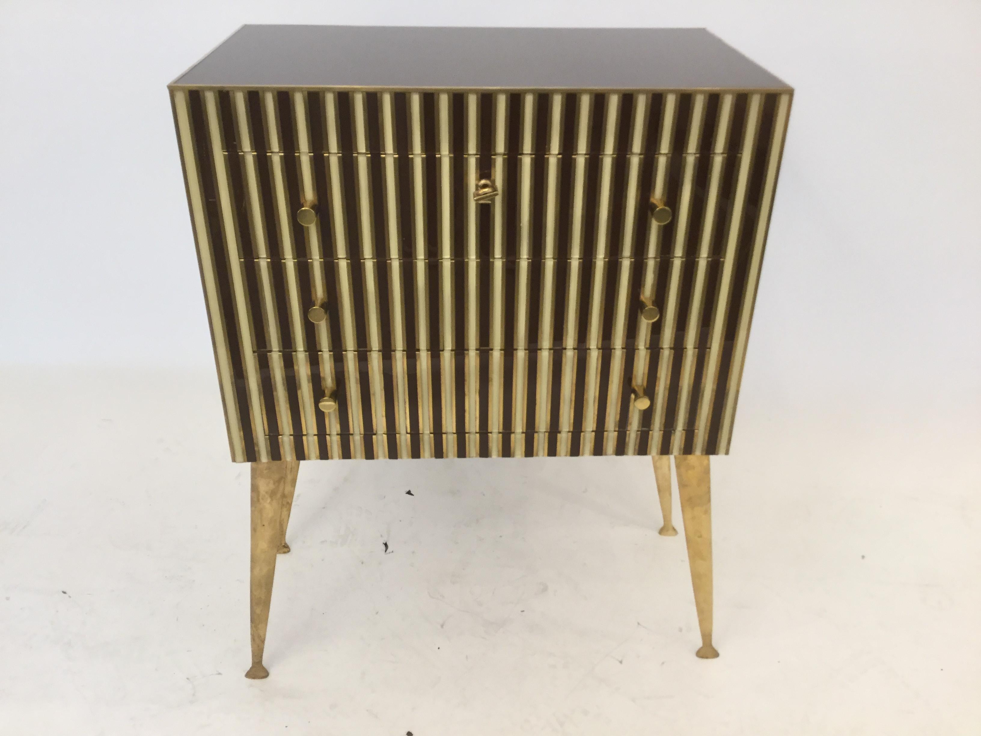 A stunning pair of side tables in glass and brass inlaid with bronze legs.