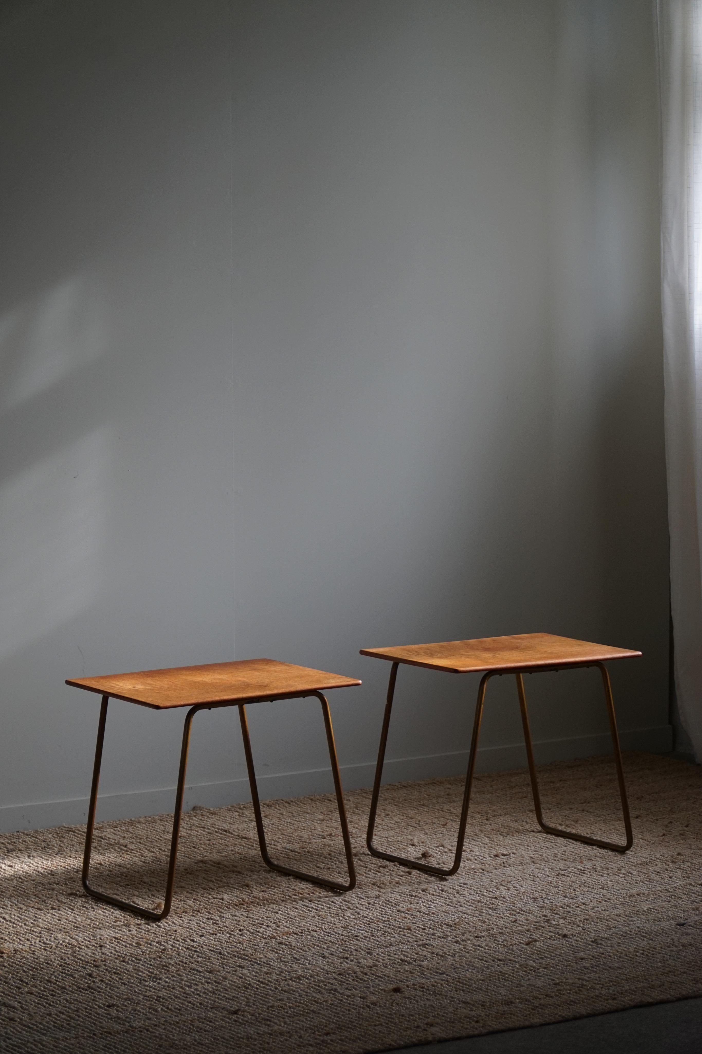 A classic and elegant pair of side tables in teak with a steel base. Made in the 1960s by a Danish cabinetmaker. 

Beautiful patina and simple lines that fit in many interior styles. A modern interior, Art Deco interior or a Classic home for