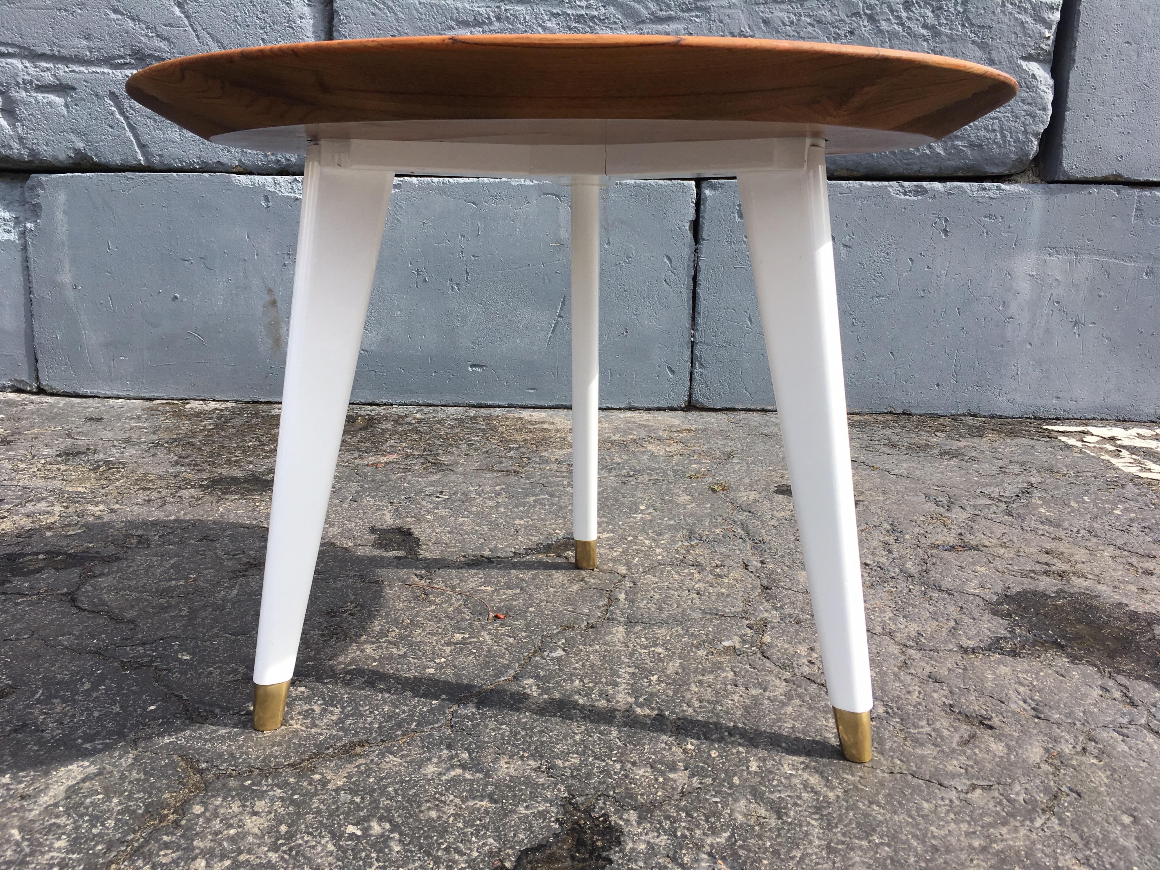 Beautiful pair of tables, two inch thick tapered teak top resting on a white lacquered base and brass tips.