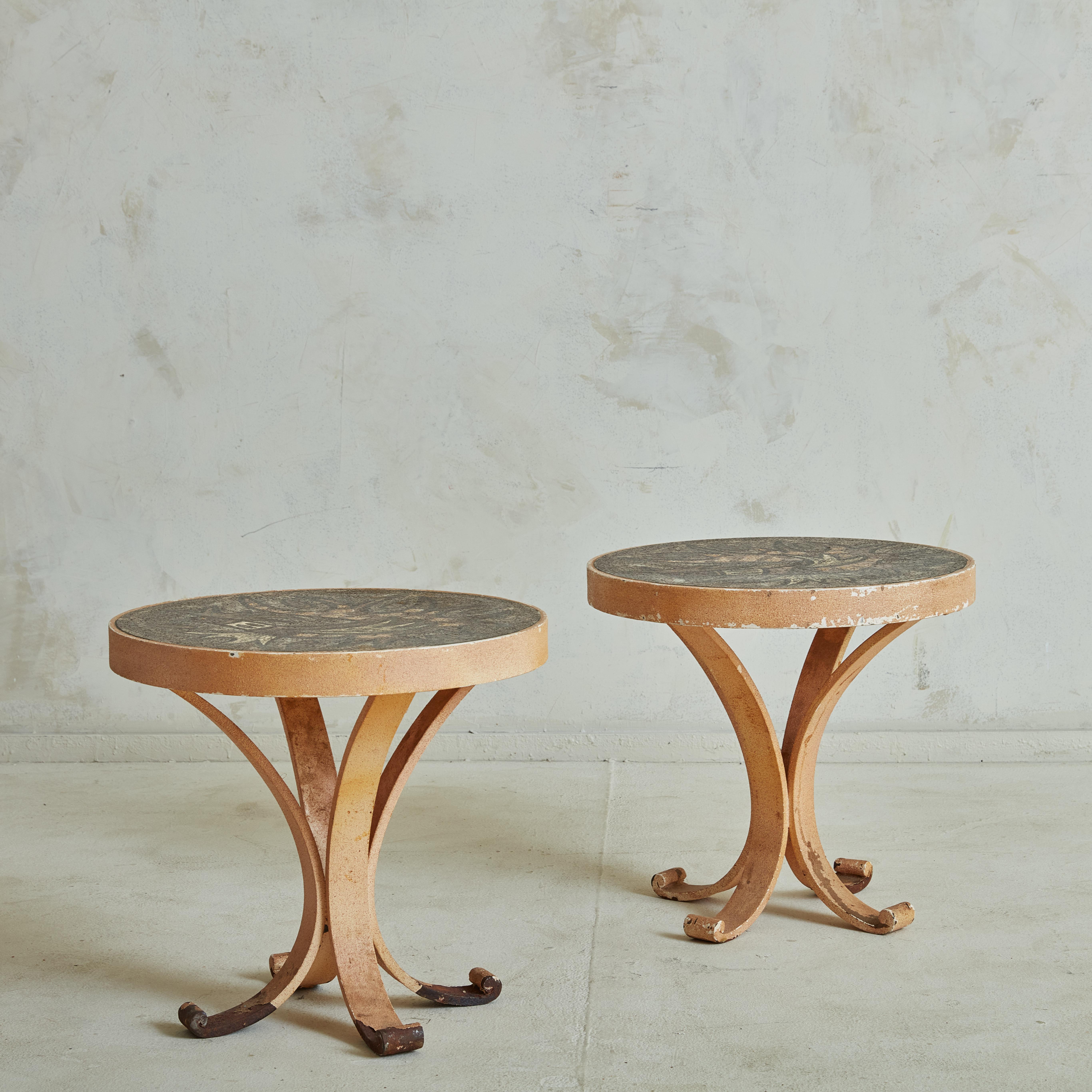 Pair of side or coffee tables in enameled lavic stone in the style of Jean Jaffeux with whimsical decorations in shades of brown and beige. The table top is sitting on a wrought iron white lacquered base with organic shapes, recalling Art Deco