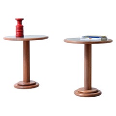 Pair of side tables with turned wooden column and green marble top.
