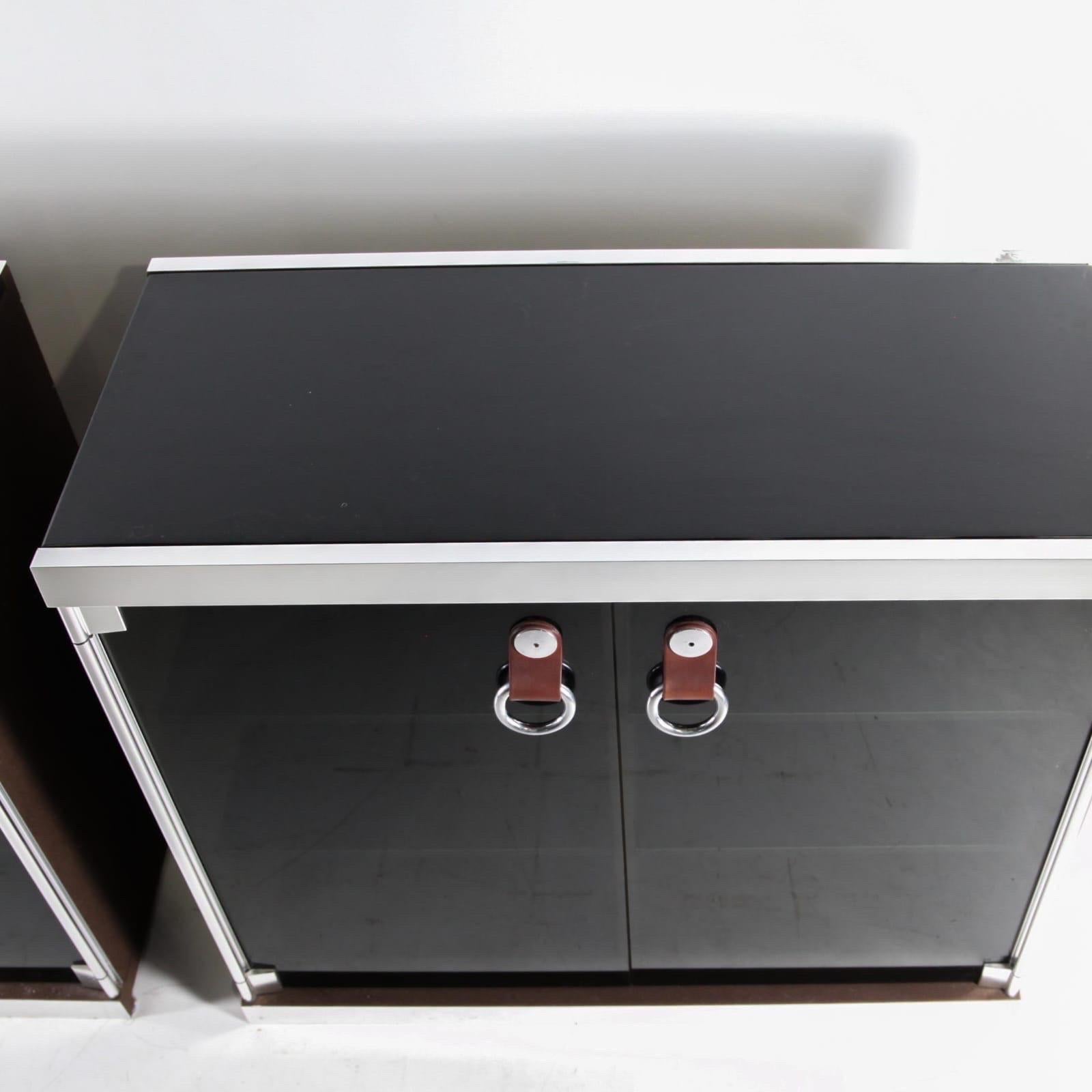 Rare pair of sideboards by Guido Faleschini for Hermès circa 1970.
Made of brown suede, stainless steel, black marble tops and stained glass doors with leather handles. 8 shelves inside. 
Very chic, very good condition. 