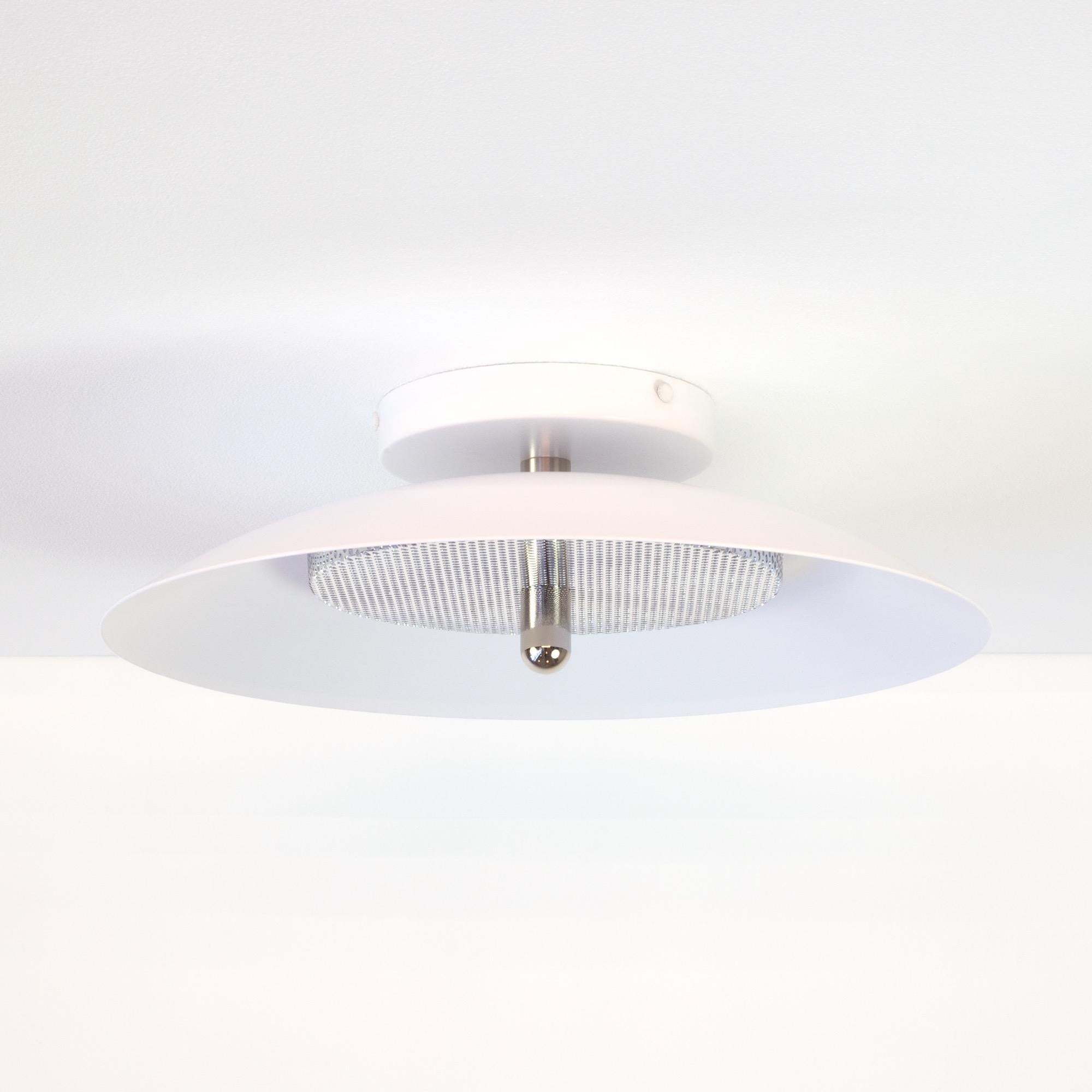 This listing is for 2 Flush Mount from Souda.
Composed of a spun metal shade that reflects light filtered through a perforated metal diffuser, the subtle warmth of the signal sconce is perfectly balanced by it’s striking form. With their refined