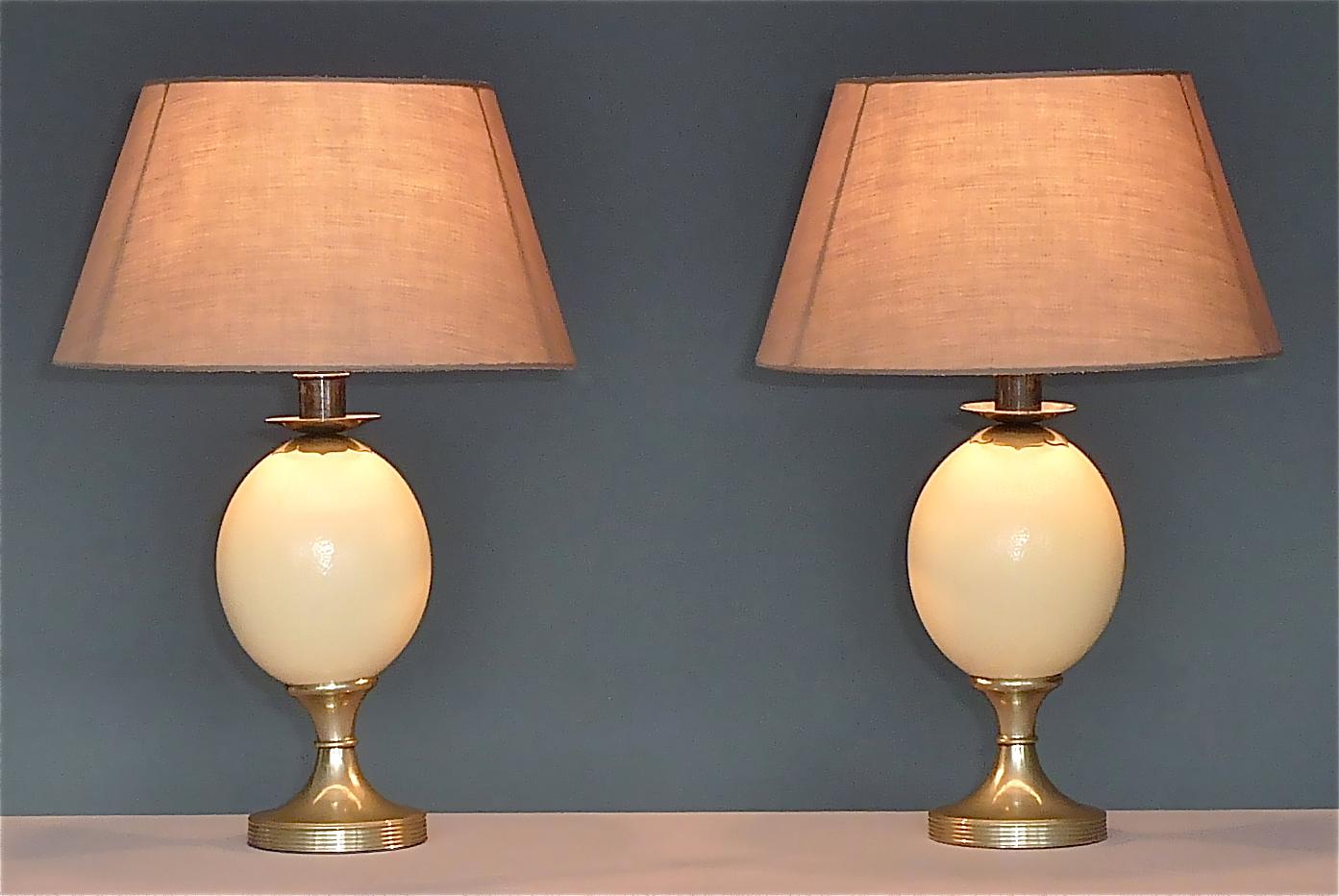 Beautiful and signed pair of ostrich egg table lamps designed and manufactured by Anthony Redmile, England, circa 1970s. The classical table lamps have each a metal base, an ostrich egg, a patinated silvered metal fitting for one E27 standard screw