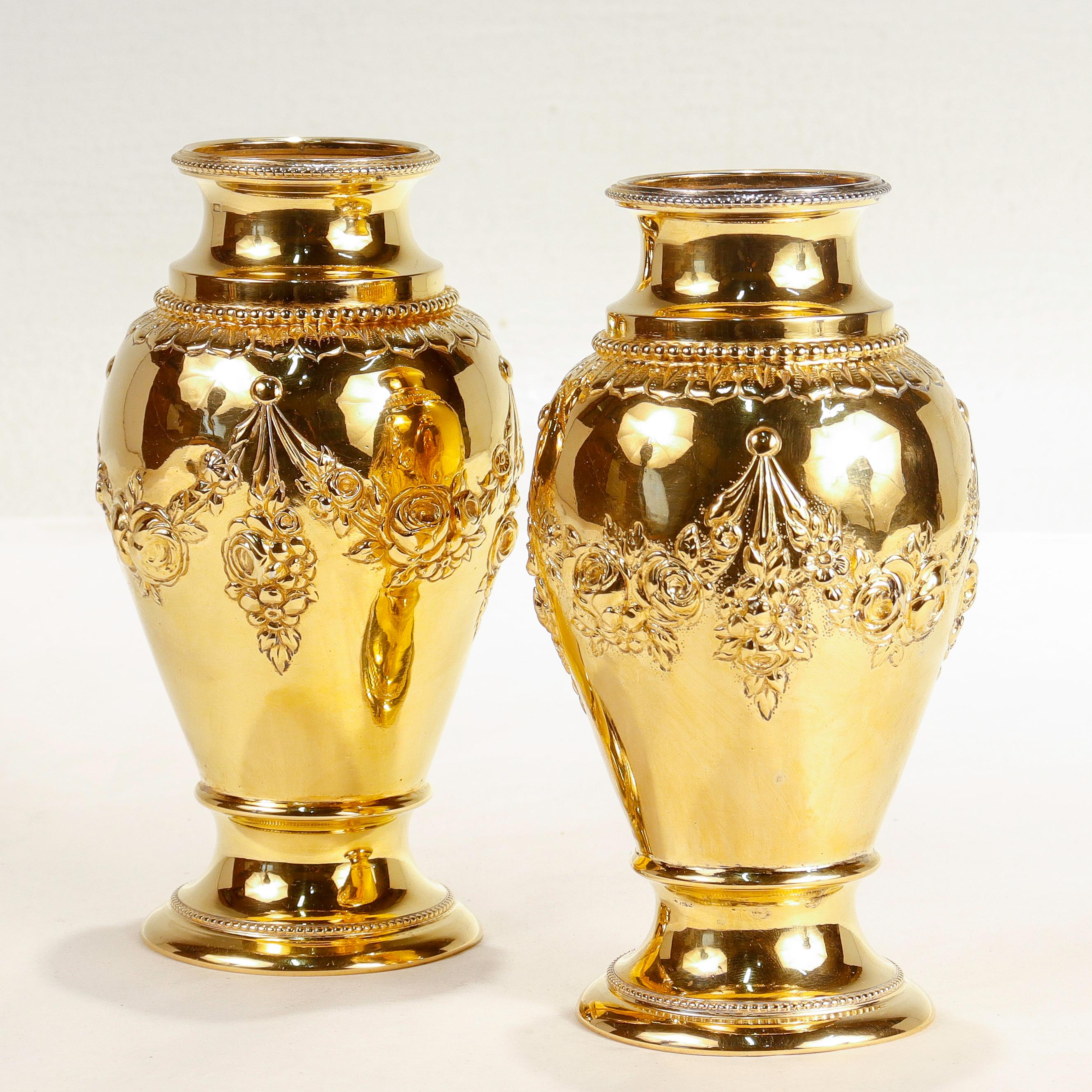A fine pair of German gilt 800 fine silver vases.

With repousse work to the bodies, beaded collar and mouth, a flared stepped foot, and gilding throughout.

By J. Kurz and Co. of Hanau, Germany.

Marked with pseudo-Hanau hallmarks to the