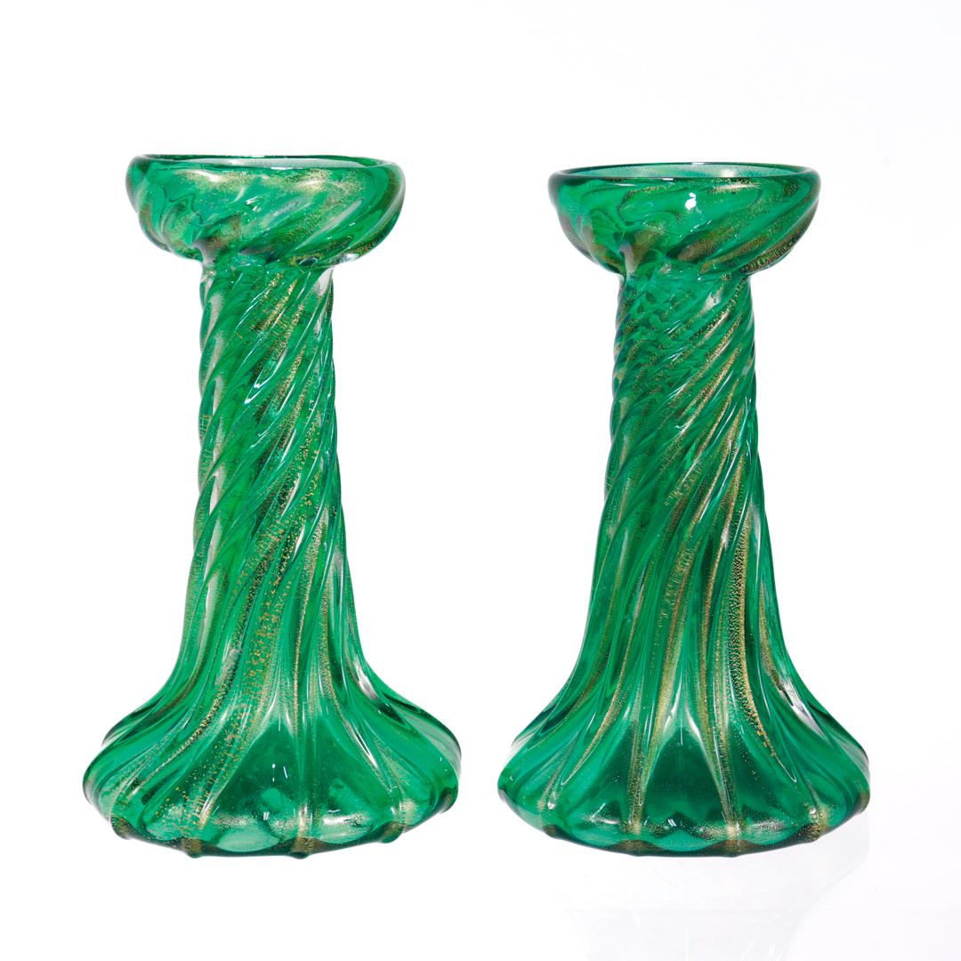 A fine pair of art glass candlesticks.

Designed by Archimede Seguso for Tiffany & Co. with obvious reference to early Favrile twist candlesticks by Louis Comfort Tiffany.

In green 'cordonato d'oro' glass with gold foil inclusions. 

Each with an